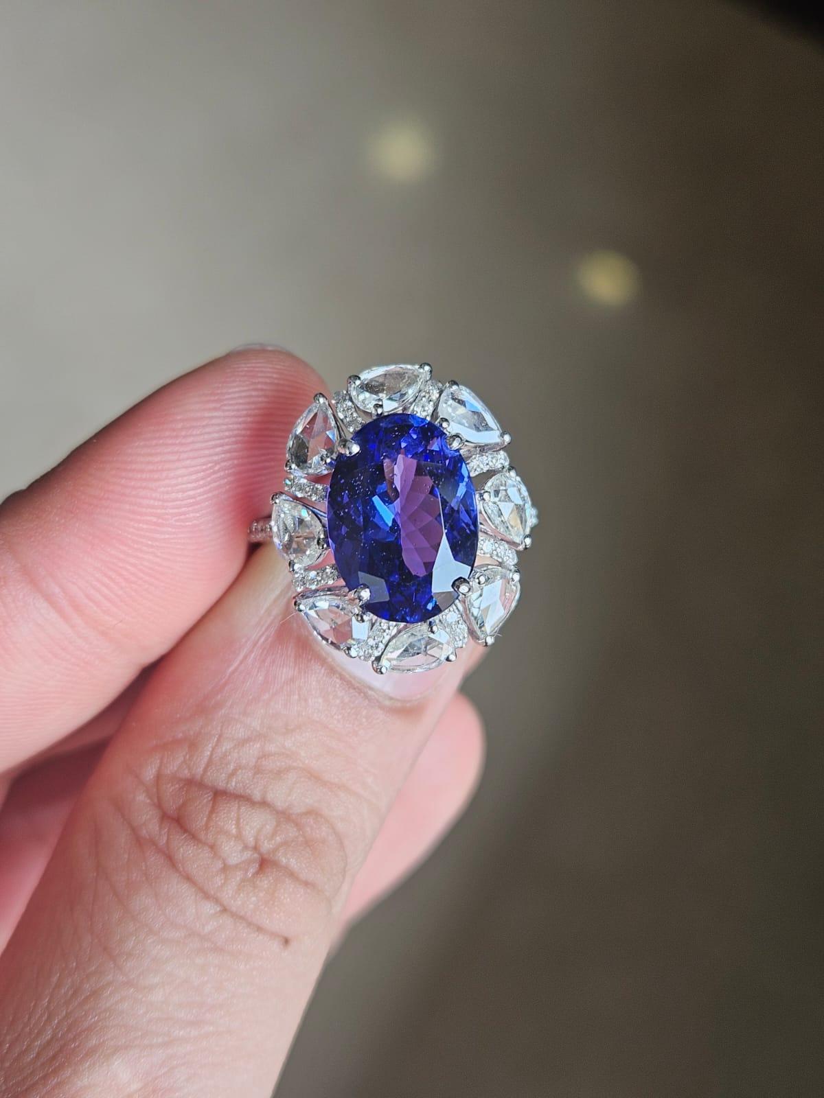 A very gorgeous and beautiful, modern style, Tanzanite Engagement Ring set in 18K White Gold & natural Diamonds. The weight of the Tanzanite is 5.16 carats. The Tanzanite is responsibly sourced from Tanzania. The Tanzania is of AA+ quality. The