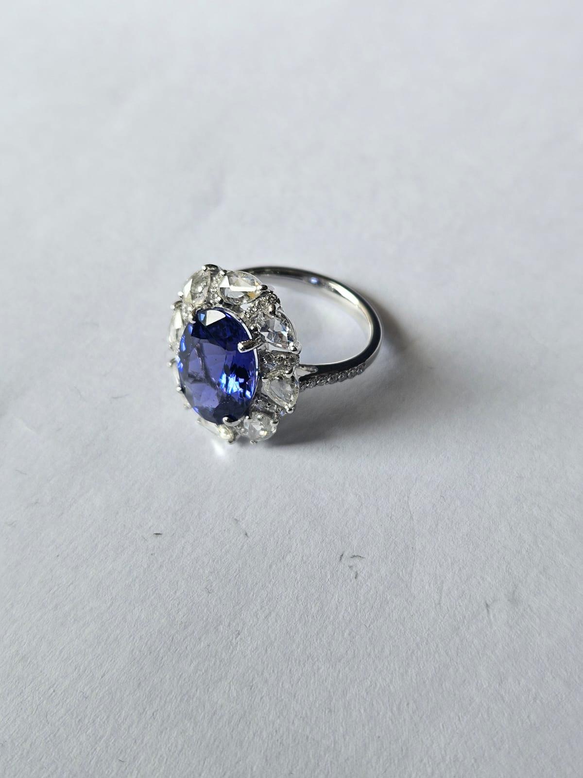 Oval Cut Set in 18K white Gold, 5.16 carats Tanzanite & Rose Cut Diamonds Engagement Ring For Sale