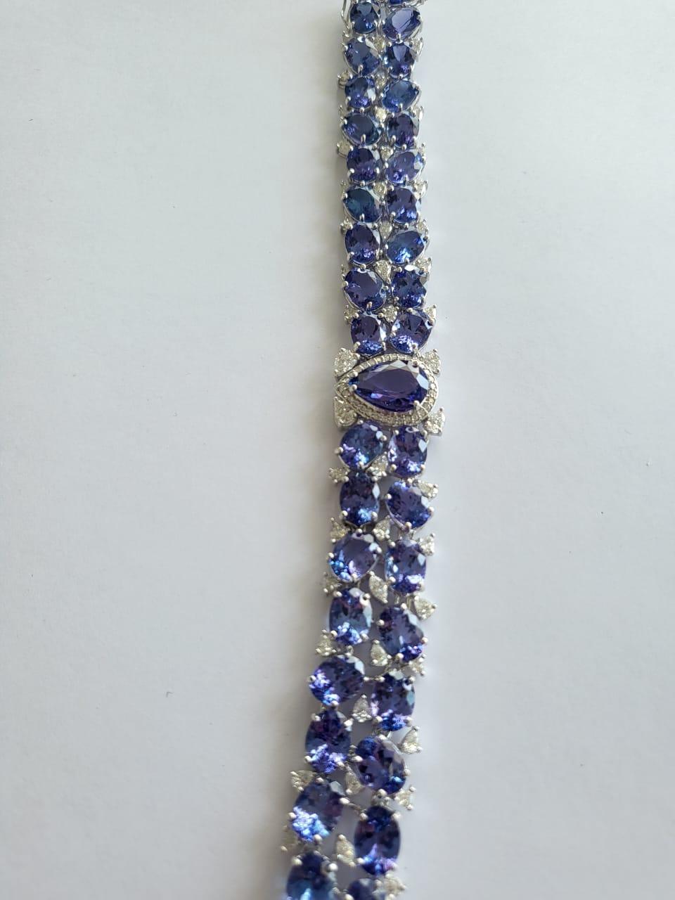 A very gorgeous and modern, Tanzanite Cuff Bracelet set in 18K White Gold & Diamonds. The combined weight of the Tanzanite is 55.81 carats. The centre pear shaped Tanzanite 3.46 carats. The Tanzanites are responsibly sourced from Tanzanite. The