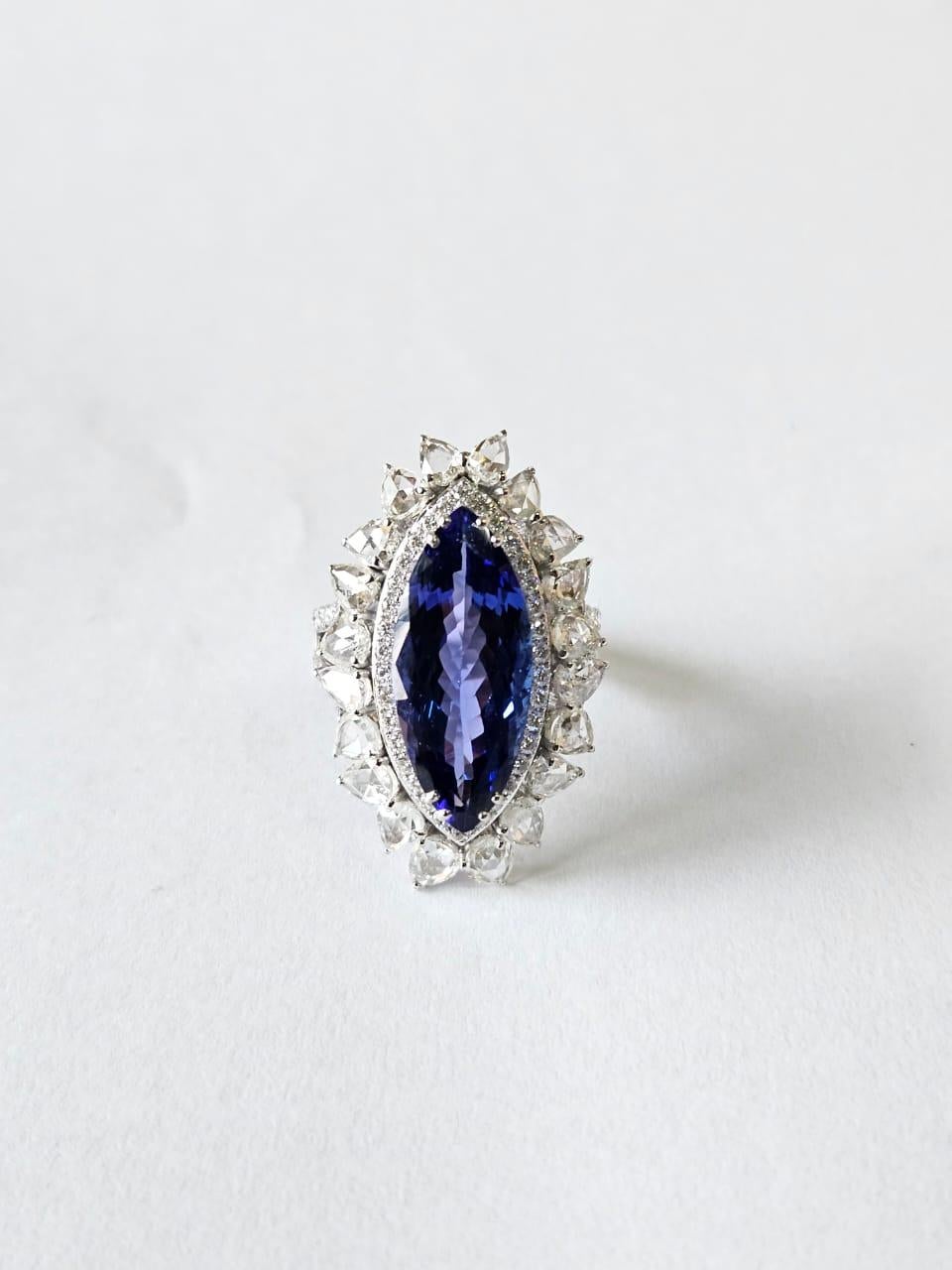 A very stunning and modern, Tanzanite Engagement Ring set in 18K White Gold & natural Diamonds. The weight of the Marquise shaped Tanzanite is 7.92 carats. The Tanzanite is responsibly sourced from Tanzania. The combined Diamonds weight is 3.54