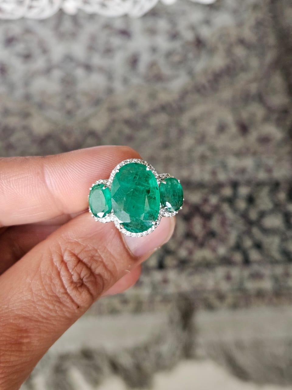 A very gorgeous and beautiful, modern style, Emerald Engagement Ring set in 18K White Gold & natural Diamonds. The combined Emeralds weight is 9.13 carats. The Emerald are completely natural, without any treatment and are of Zambian origin. The