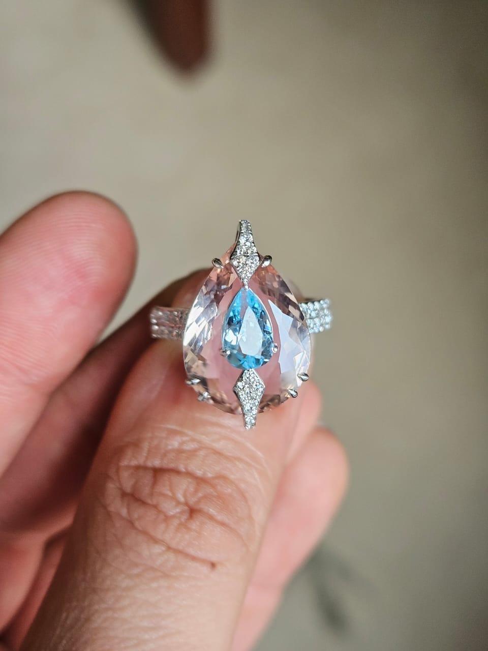 A very gorgeous and beautiful, one of a kind, Aquamarine & Morganite Engagement Ring set in 18K White Gold & Diamonds. The weight of the pear shaped Morganite is 6.96 carats. The weight of the pear shaped Aquamarine is 0.79 carats. The Aquamarine is