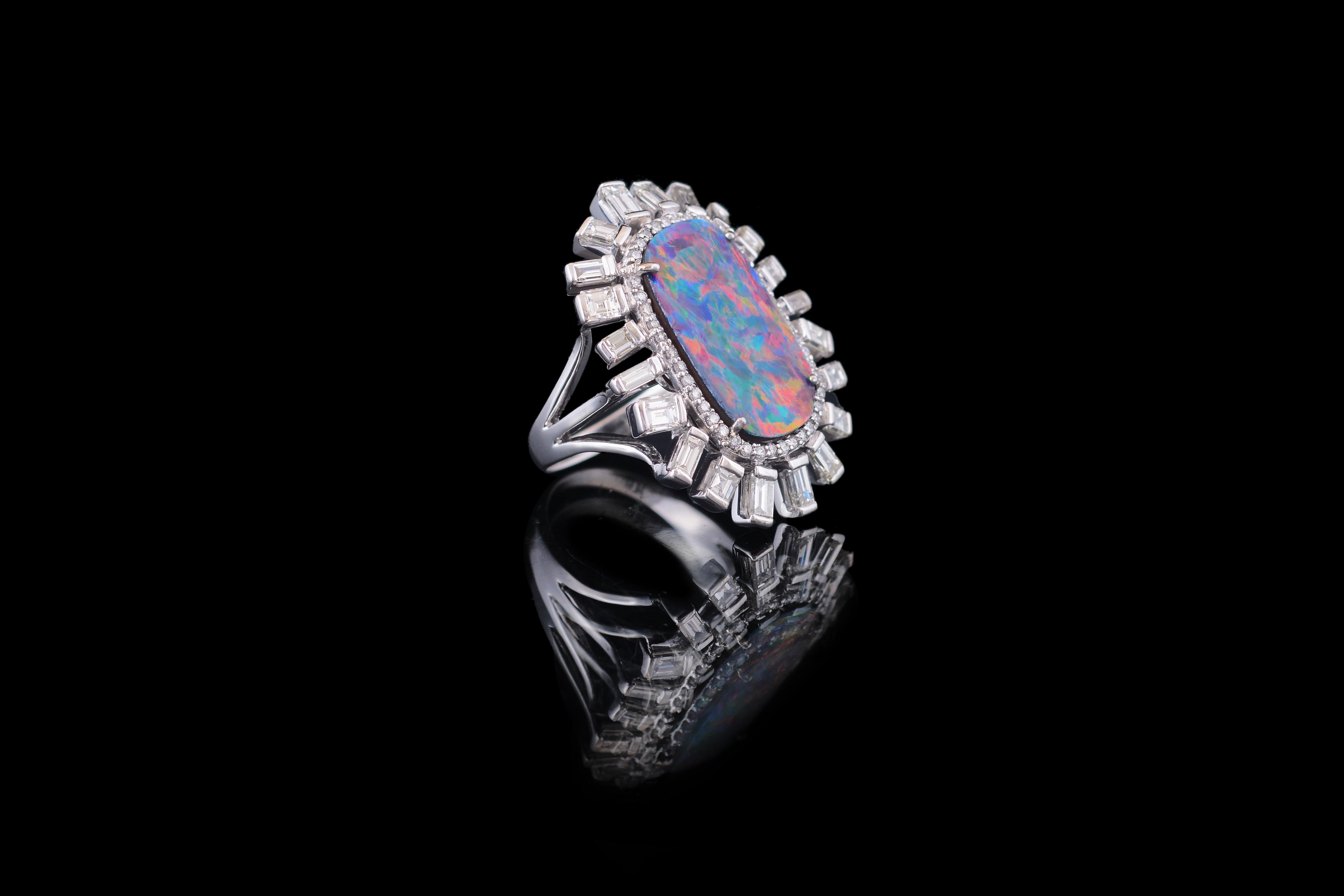 A very gorgeous doublet opal and baguette diamonds cocktail ring. The opal is a Australian natural doublet opal weighing 4.26 carats. The play of colour on this opal is red, blue and green. The baguette diamonds weigh 1.99 carats. The ring is made