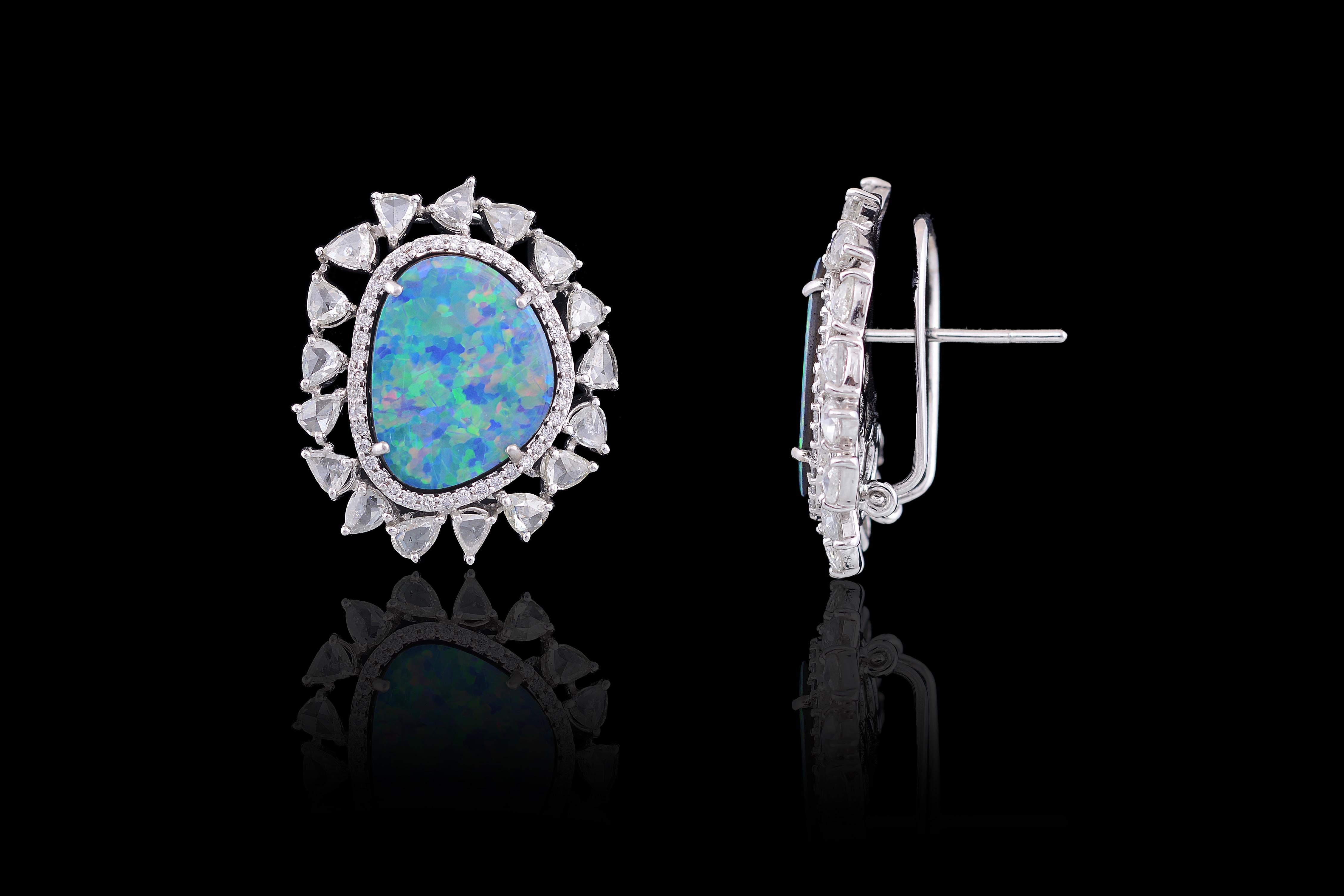 Stunning Australian doublet opal studs set in 18K white gold and rose cut diamonds. The doublet opal weigh 9.64 carats, whereas the total weight of the diamond is 3.19 carats. The earrings have a clip back and a simple pull - push mechanism for