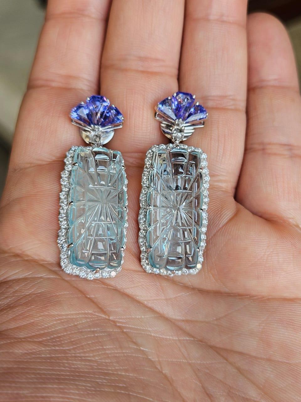 A very gorgeous and beautiful, modern style, Aquamarine & Tanzanite Earrings set in 18K White Gold & natural Diamonds. The weight of the carved Aquamarine is 41.37 carats. The Aquamarine are hand-carved in our very own workshop. The weight of the