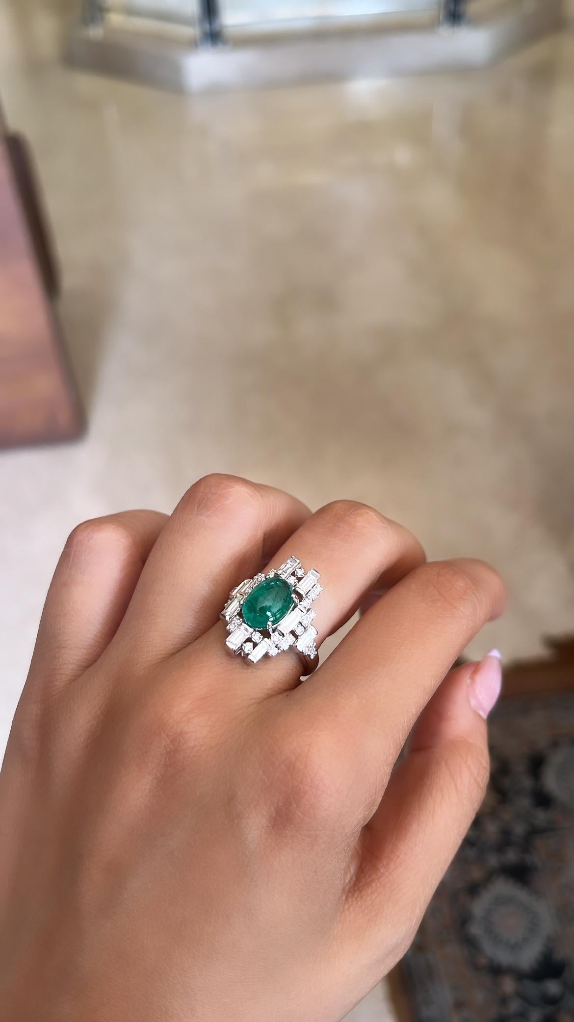 A very beautiful and one of a kind, Emerald Cabochon Engagement Ring set in 18K White Gold & Diamonds. The weight of the Emerald Cabochon is 2.61 carats. The Emerald is completely natural, without any treatment and is of Zambian origin. The combined