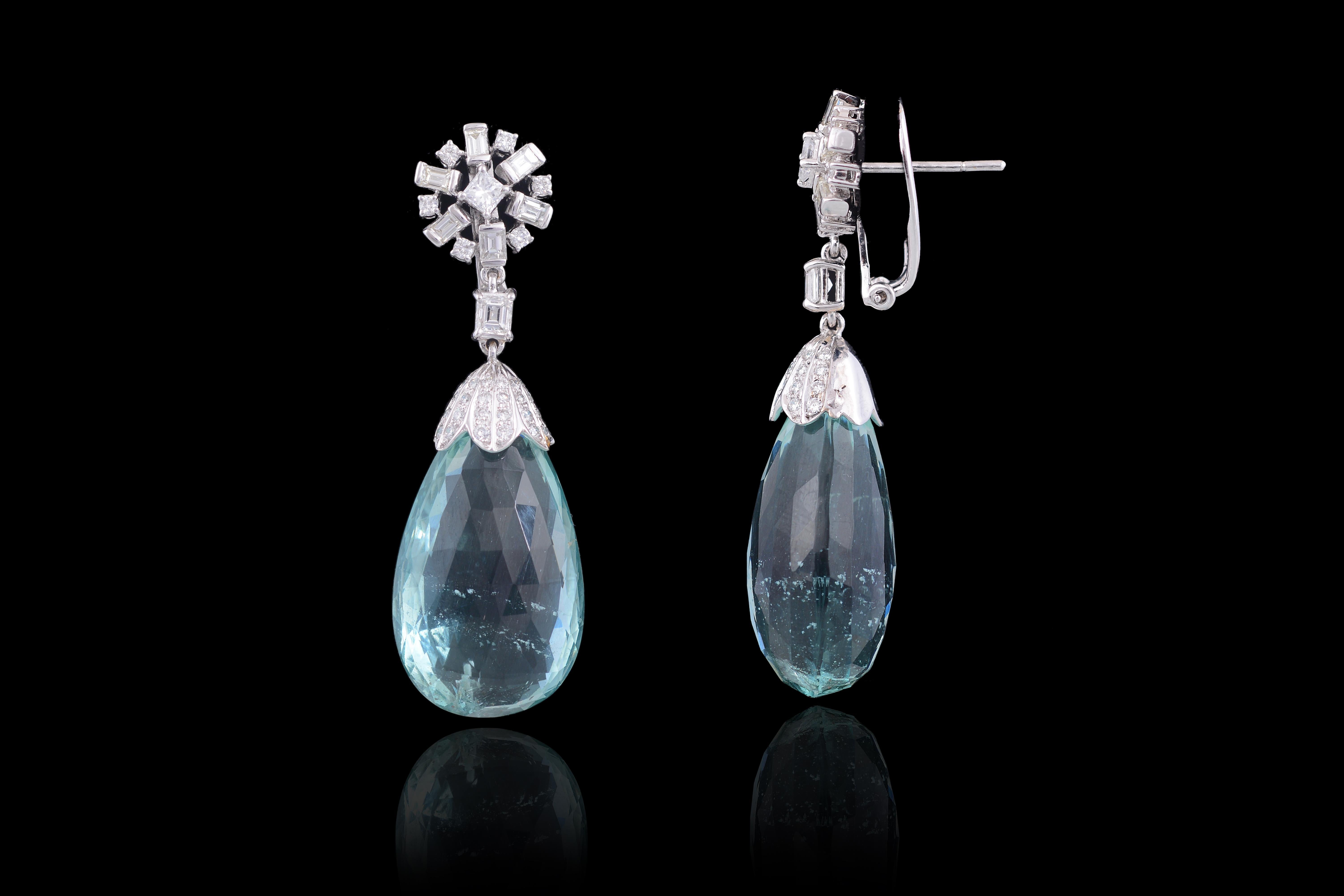 Gorgeous green aquamarine faceted drop earrings weighing 74.16 carats with baguette and princess diamonds weighing 1.73 carats, set in 18K white gold. The aquamarine is natural and has not been subject to any treatment or thermal process. The