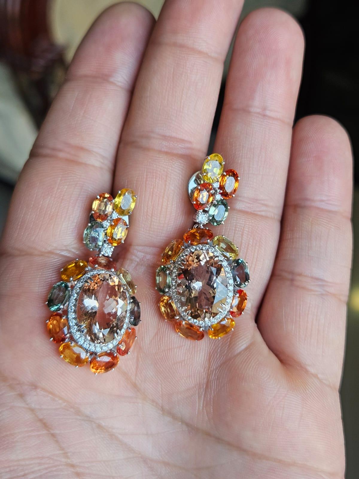 Un pezzo unico di orecchini pendenti con Morganite e zaffiri multipli in oro bianco 18 carati e diamanti naturali. Il peso delle Morganiti ovali è di 10,30 carati. Il peso degli zaffiri multipli è di 15.84 carati. Gli Zaffiri Multi sono di origine