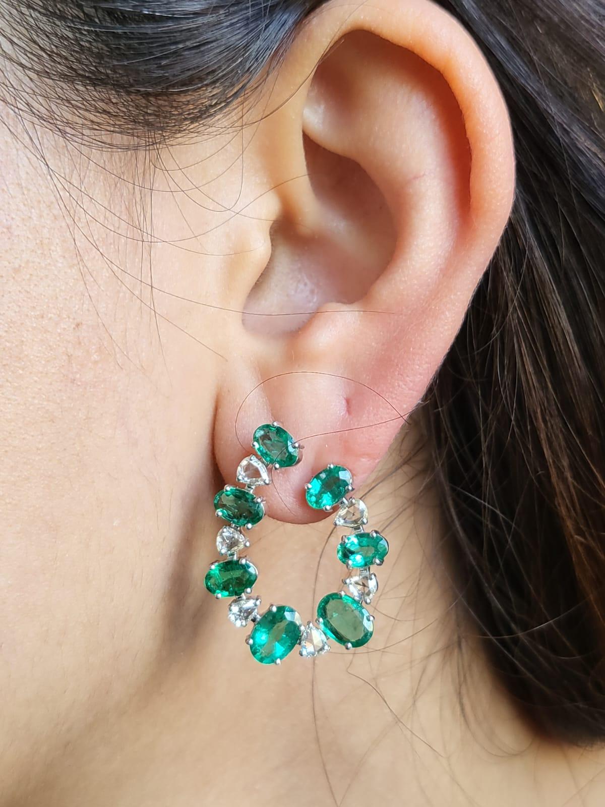 A very beautiful and chic, Emerald Hoop Earrings set in 18K White Gold & Diamonds. The weight of the Emeralds is 6.21 carats. The Emeralds are completely natural, without any treatment and is of Zambian origin. The weight of the Rose Cut Diamonds is