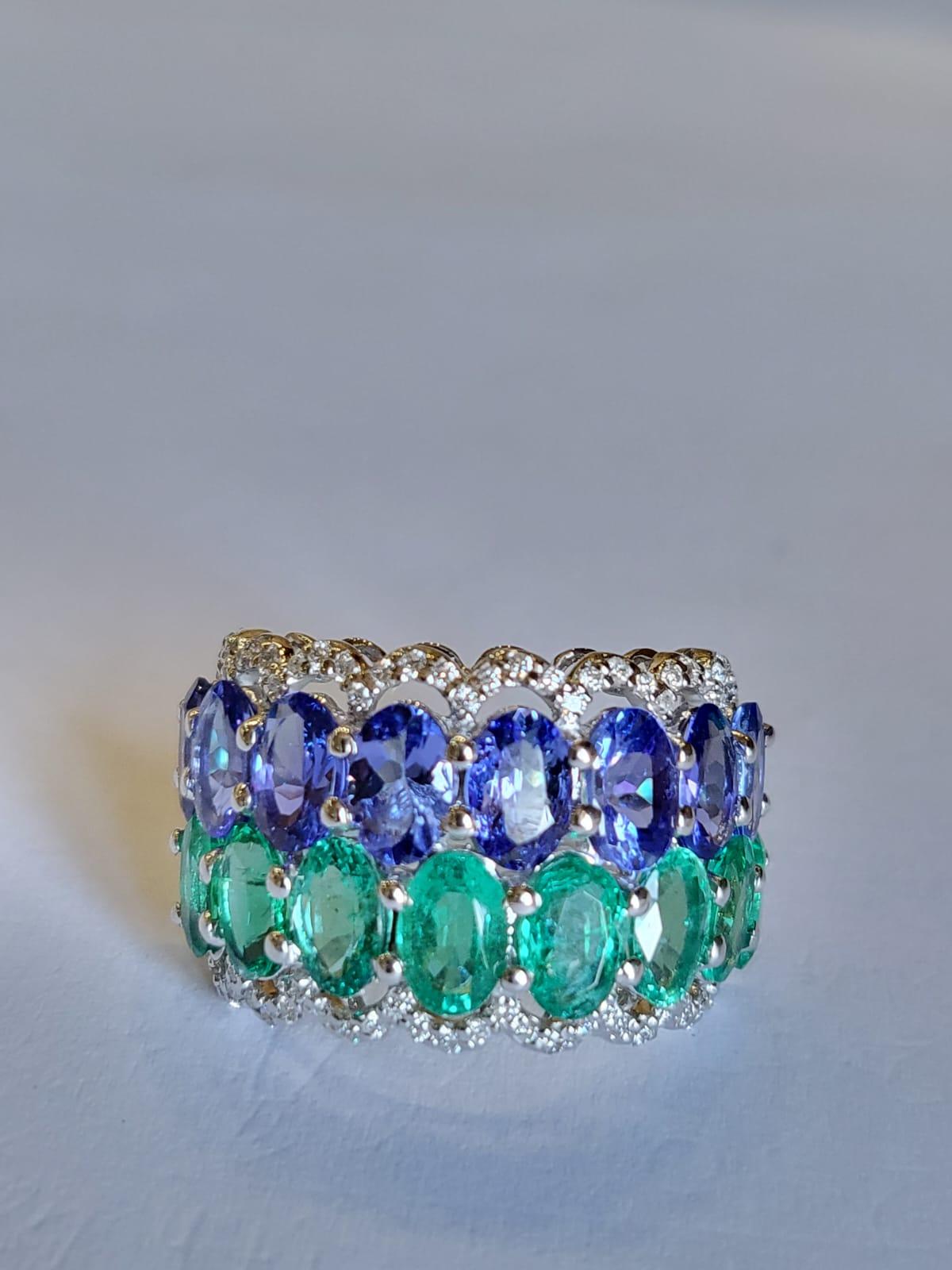 A very gorgeous and fine crafted, Emerald & Tanzanite Band Ring set in 18K White Gold & Diamonds. The weight of the Emerald ovals is 3.28 carats. The Emerald is of Zambian origin and is completely natural, without any treatment. The weight of the