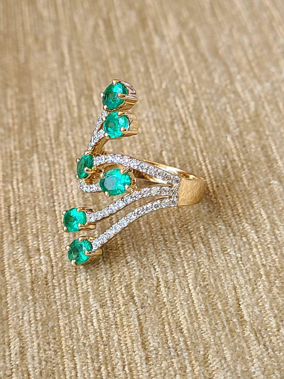 A very dainty and beautiful Emerald Band Ring set in 18K White Gold & Diamonds. The weight of the Emeralds is 1.97 carats. The Emeralds are completely natural, without treatment and are of Zambian origin. The weight of the Diamonds is 0.64 carats.