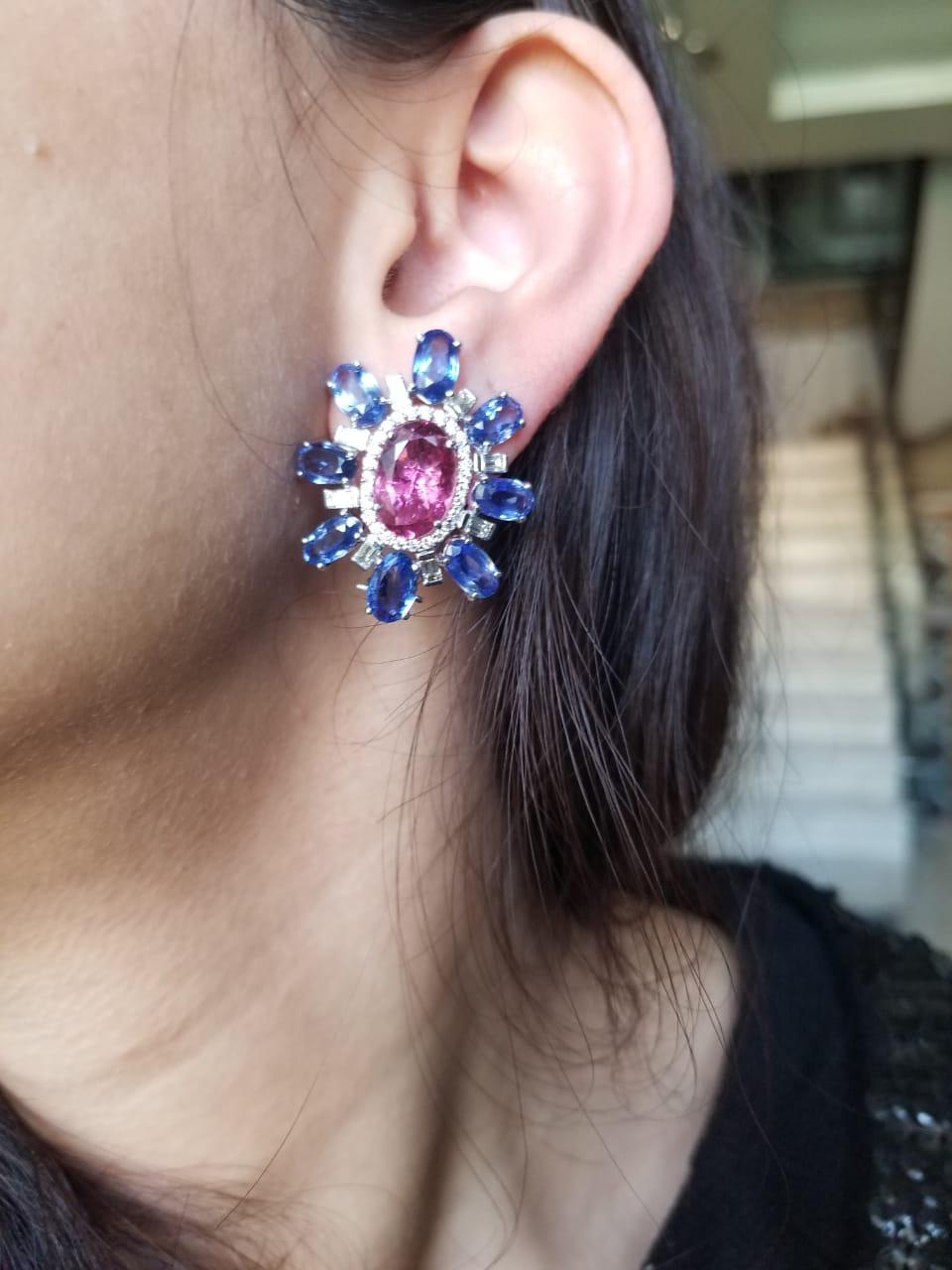 Gorgeous pair of stud earrings, set in 18 Karat white gold, with natural pink tourmaline and natural Ceylon Blue Sapphires and baguette diamonds. The earrings have a level back and a simple pull - push mechanism for added safety. The weight of