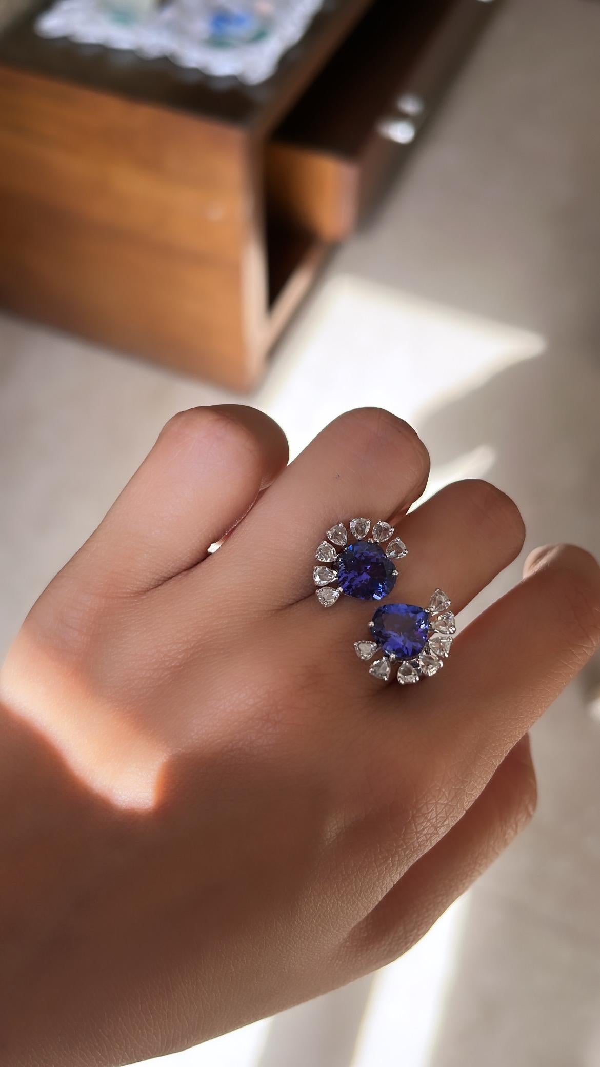 A very gorgeous and one of a kind, Tanzanite Cocktail/ Engagement Ring set in 18K Gold & Diamonds. The weight of the heart shaped Tanzanites is 5.01 carats. The Tanzanites are ethically sourced from Tanzania & are free of any conflict. The weight of