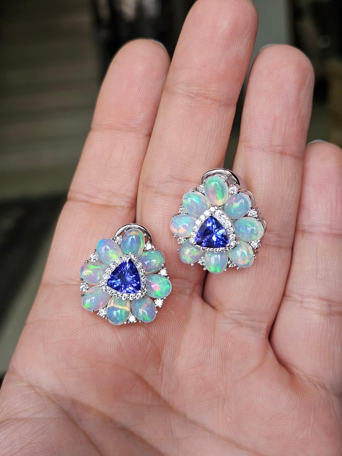 A very gorgeous and beautiful, modern style, Tanzanites & Opal Stud Earrings set in 18K White Gold & natural Diamonds. The weight of the Tanzanites is 2.35 carats. The Tanzanites are responsibly sourced from Tanzania. The weight of the Ethiopian