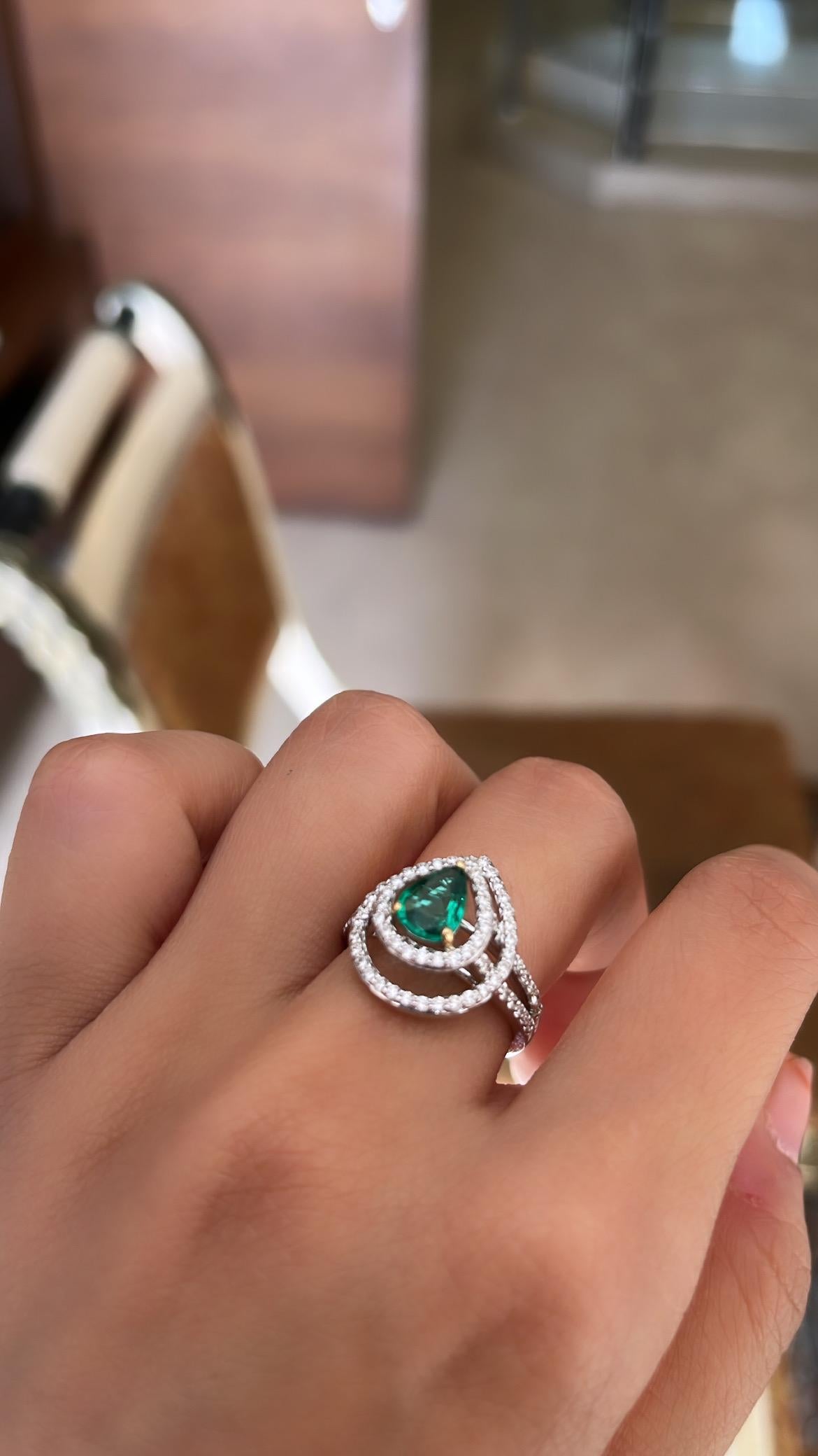 A very beautiful and wearable Emerald Cocktail/ Engagement Ring set in 18K Gold & Diamonds. The weight of the Emerald pear is 0.69 carats. The Emerald is of Zambian origin and is completely natural without any treatment. The weight of the Diamonds