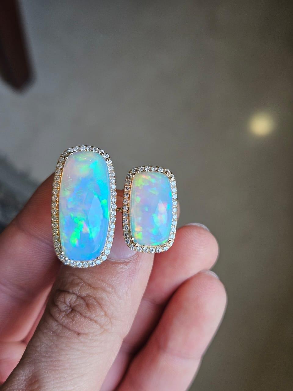 A very gorgeous and beautiful, Opal Cocktail Ring set in 18K Yellow Gold & Diamonds. The weight of the two Opal pieces is 14.04 carats. The Diamonds weight is 0.68 carats. Net 18K Gold weight is 6.29 grams. The gross weight of the Ring is 9.24
