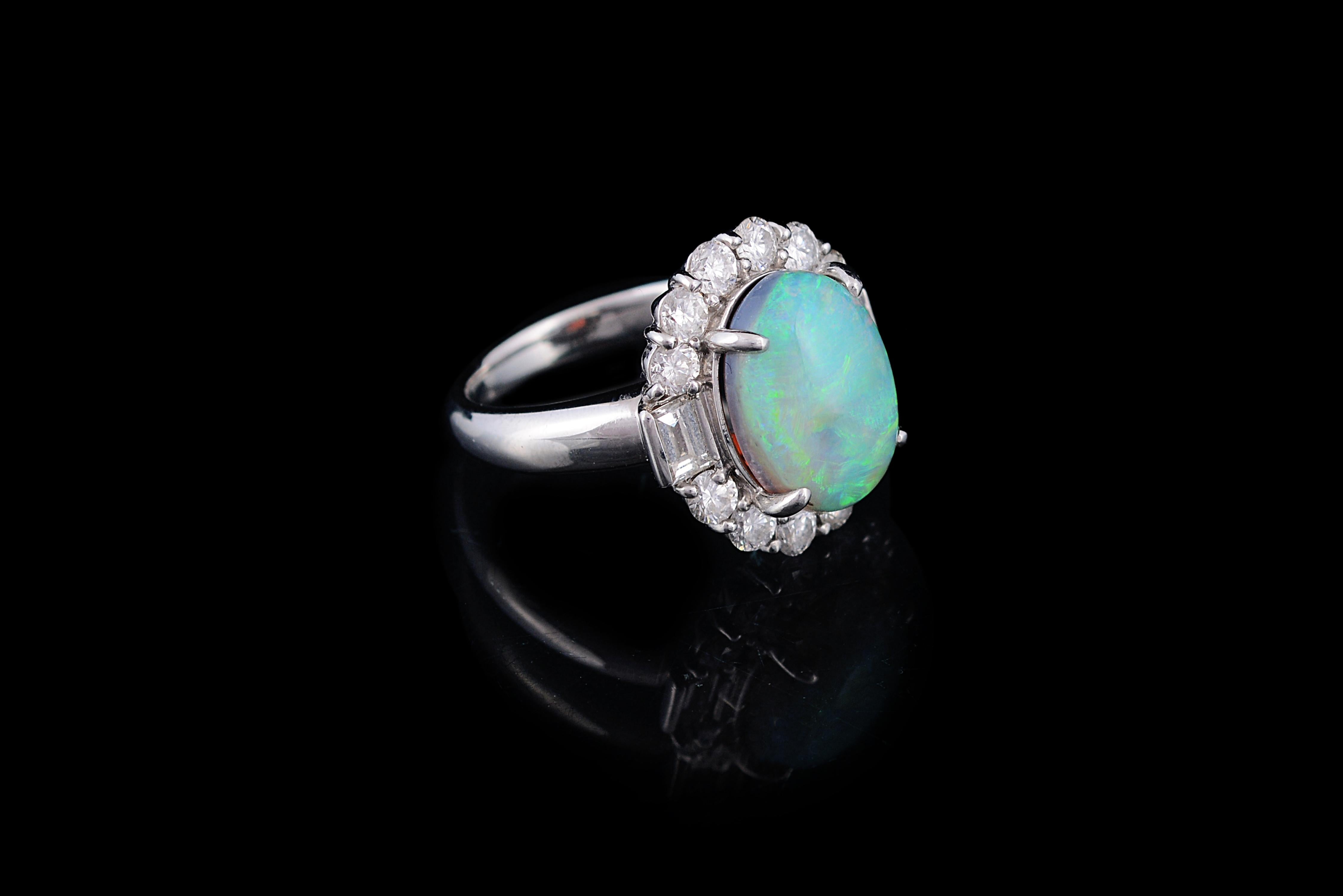For those who would like to be different, a very beautiful Australian opal and diamonds engagement ring. The gorgeous opal, weighs 4.49 carats, and has a gorgeous blue, green play of colour. The weight of the diamonds is 1.37 carats. The ring is