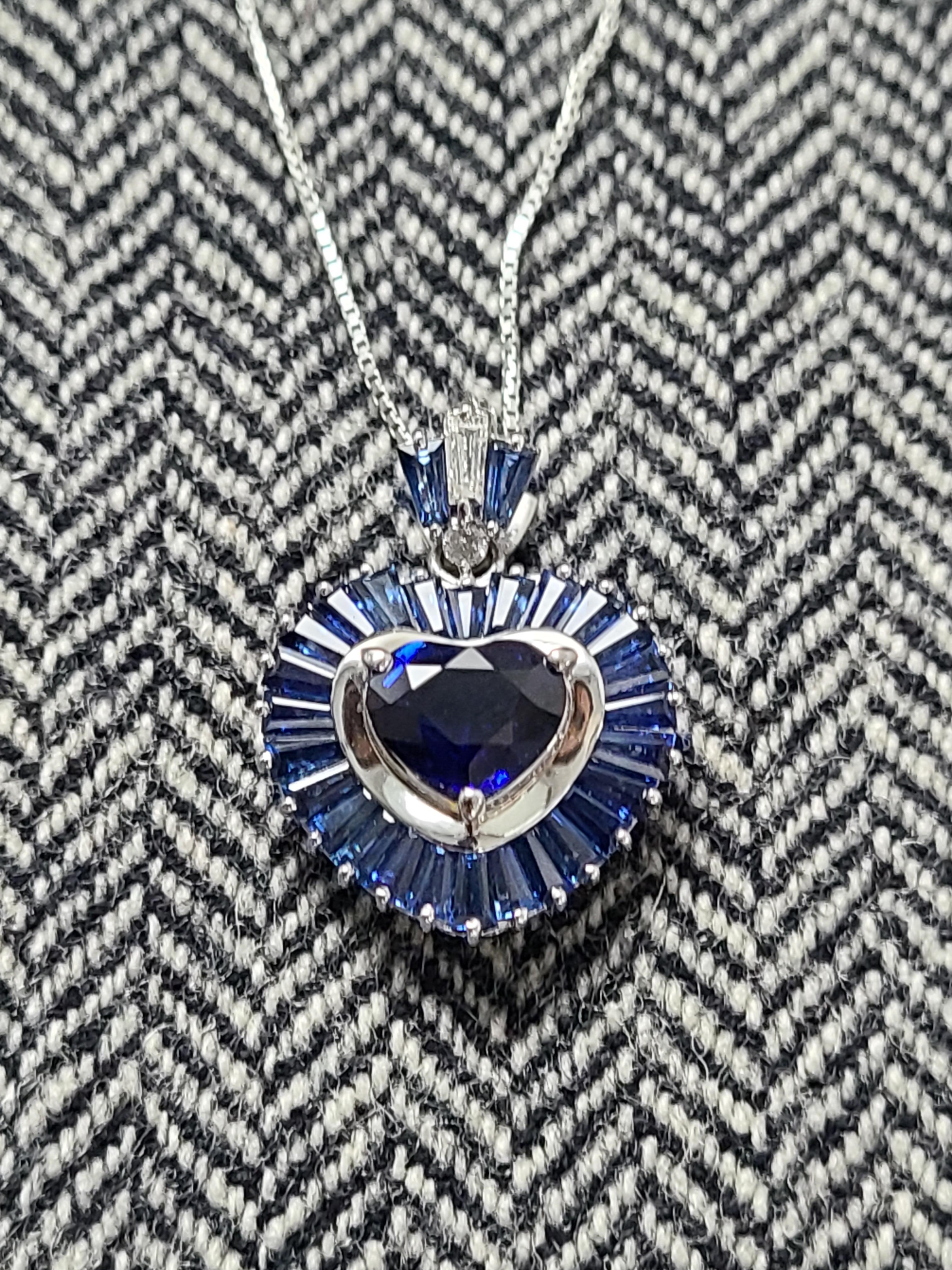 A gorgeous heart shape blue sapphire surrounded by baguette cut blue sapphire made in platinum PT 900 and chain made in platinum PT 850 . The blue sapphire weight is 2.28 carats , surrounding blue sapphire baguette weight is 1.38 carats , the