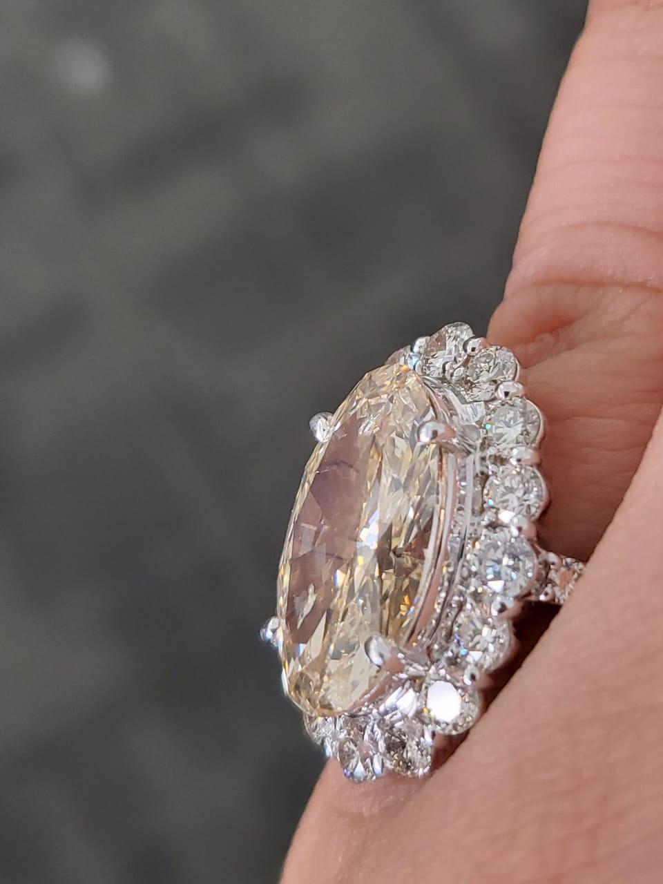 A very beautiful and stunning, Diamonds Engagement Ring set in Platinum 900 & Diamonds. The weight of the centre oval Diamond is 6.15 carats. The colour of the Diamond is under S - Slight Yellow Brown. The clarity of the Diamond is SI2. The Diamond