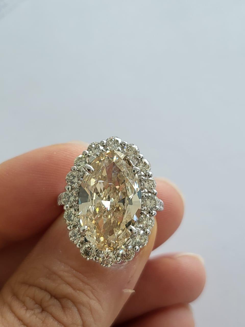 Oval Cut Set in PT900, 6.15 carats, Slight Yellow Brown Oval Diamond Engagement Ring For Sale