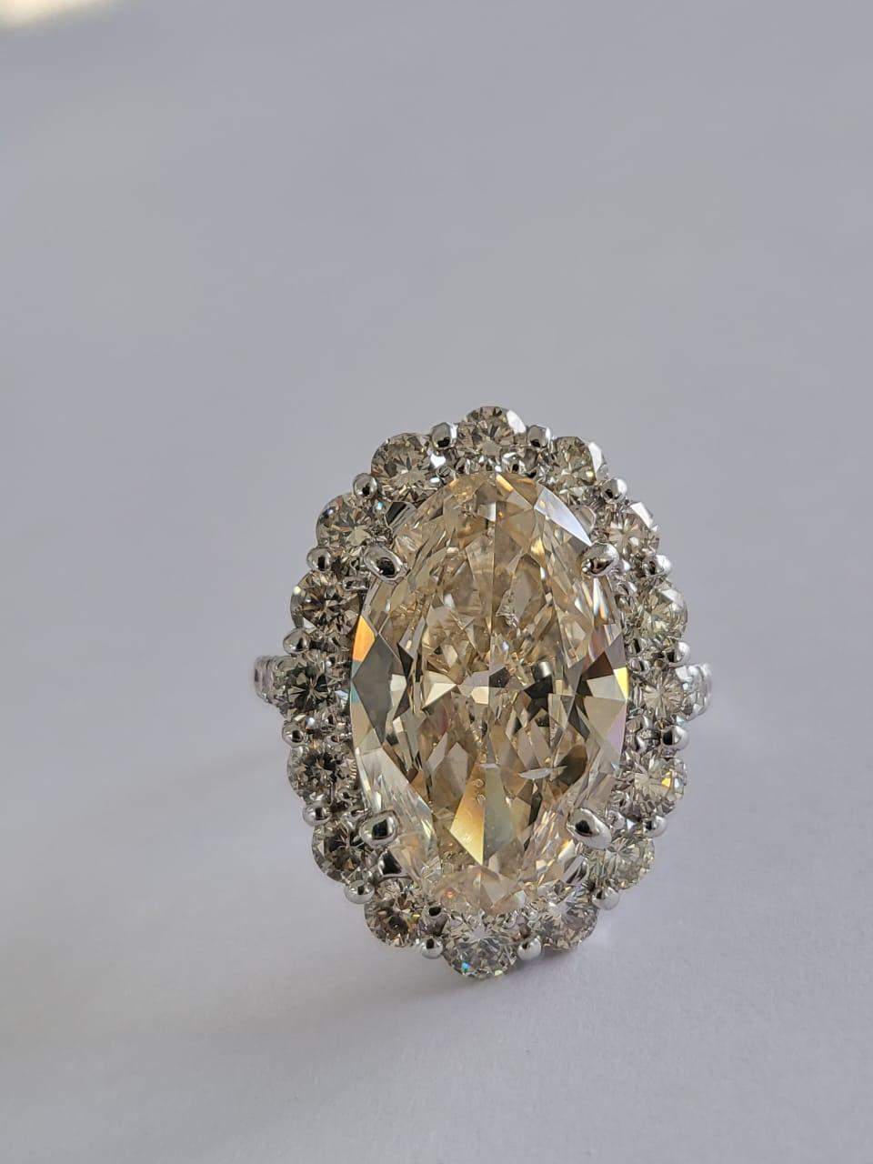 Set in PT900, 6.15 carats, Slight Yellow Brown Oval Diamond Engagement Ring For Sale 1