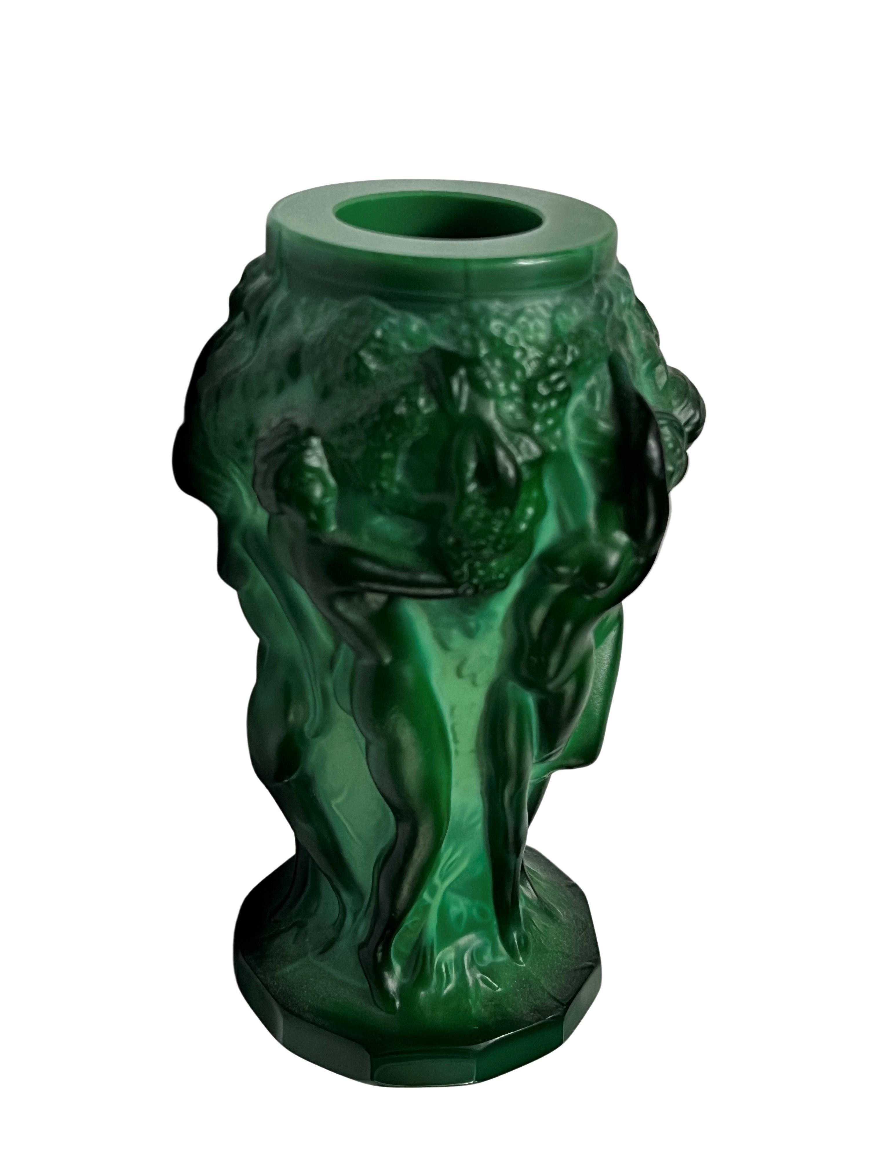 Set of a flower vase, two boxes and two perfume bottles out of malachite glass, a late version of the Ingrid series by Curt Schlevogt. 

The charming vase is heavily molded with flat cut twelve sided bases with six nude maidens in relief, picking