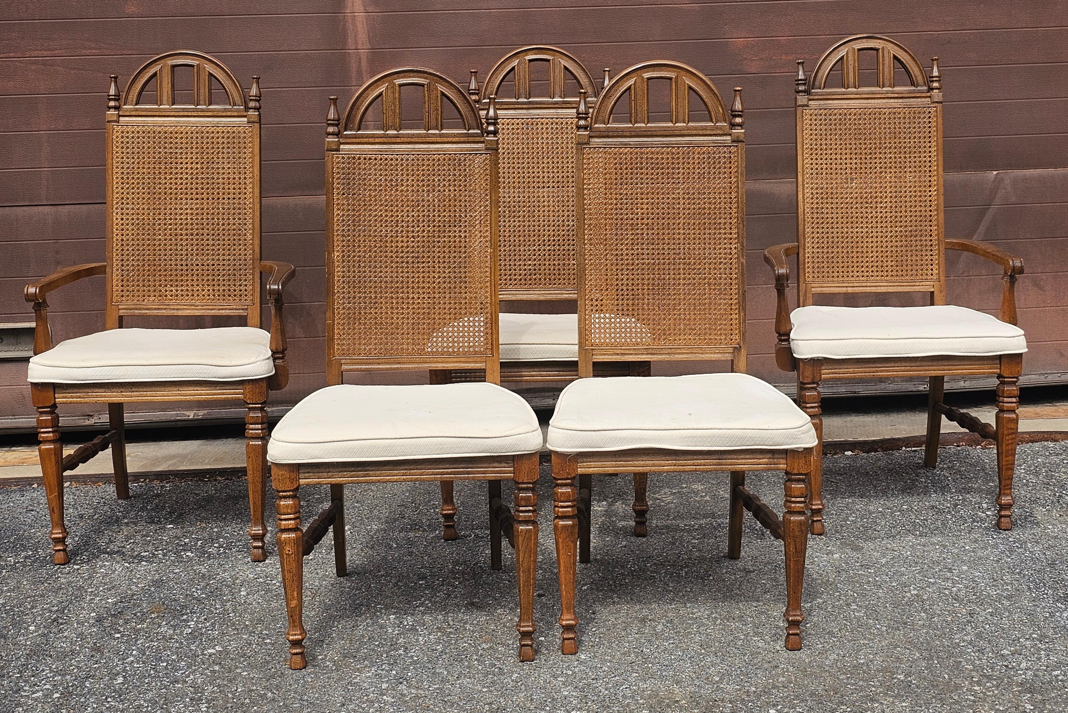 A Set of five Mid Century Bassett Furniture Provincial Style Walnut and Cane high back dining Chairs. Two armchairs and 3 side chairs.