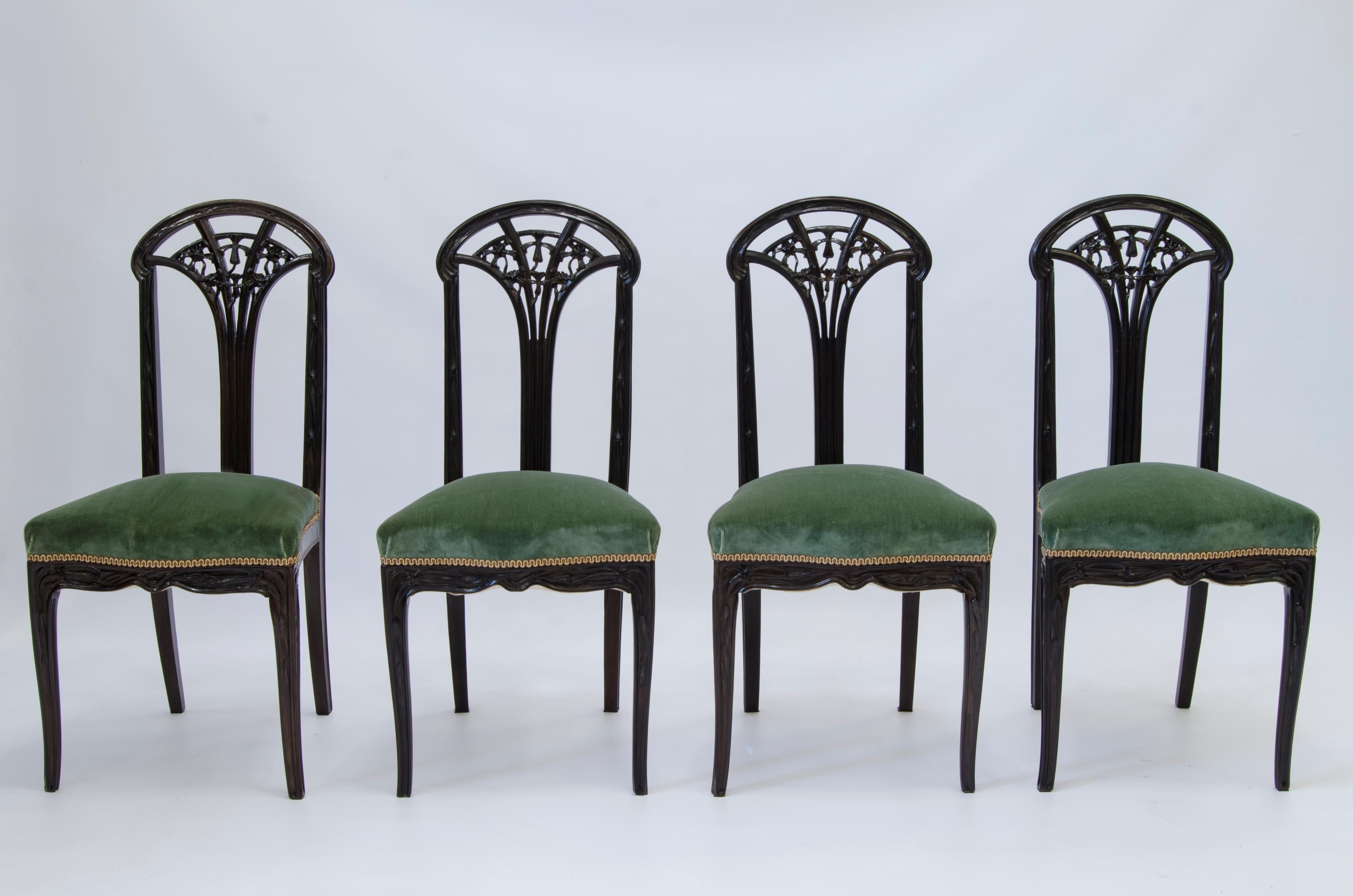 An Art Nouveau set consisting of a wooden table with a Violet d'Afyon marble top, two open-sided armchairs, and four chairs, model 