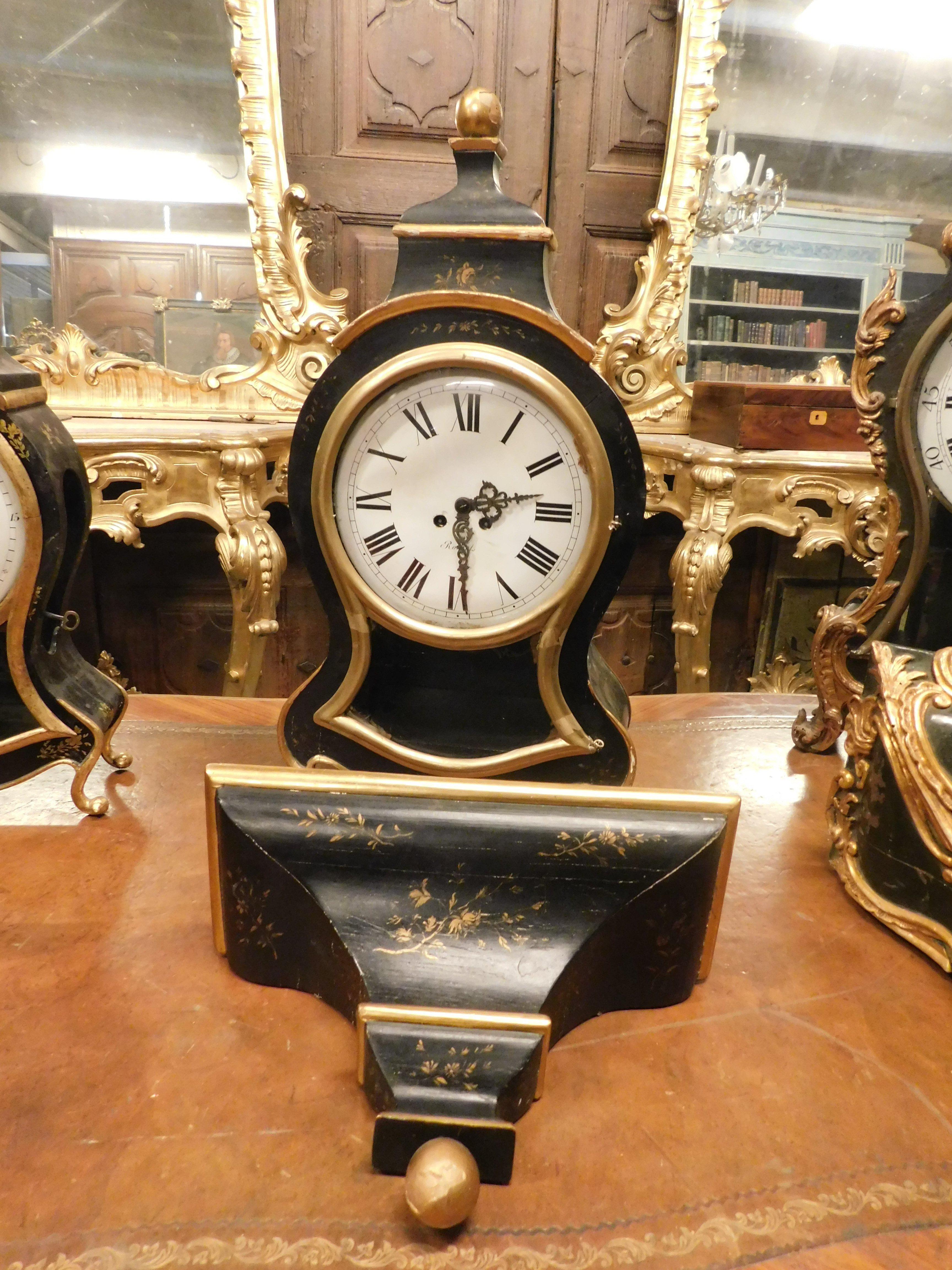 Italian set n.3 clocks ebonized wood, profiles and feet decorated gilded plant motifs For Sale
