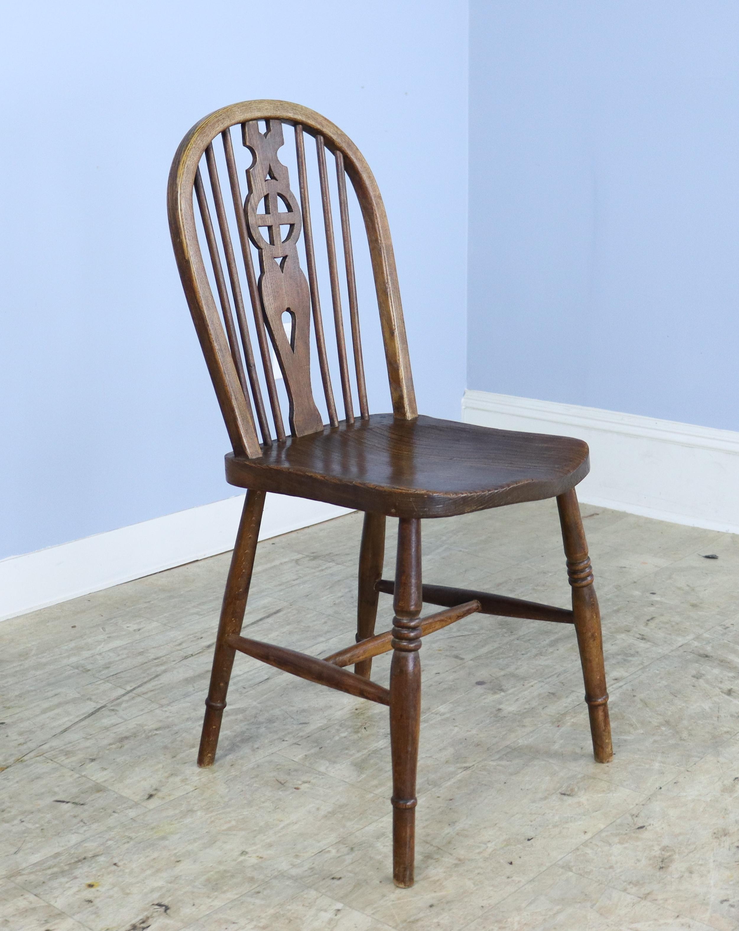 A set of ten English elm Windsor chairs in very good antique condition. The traditional wheelback design is slightly different in each handmade chair. These would look wonderful around any number of table styles. Good color and patina and quite