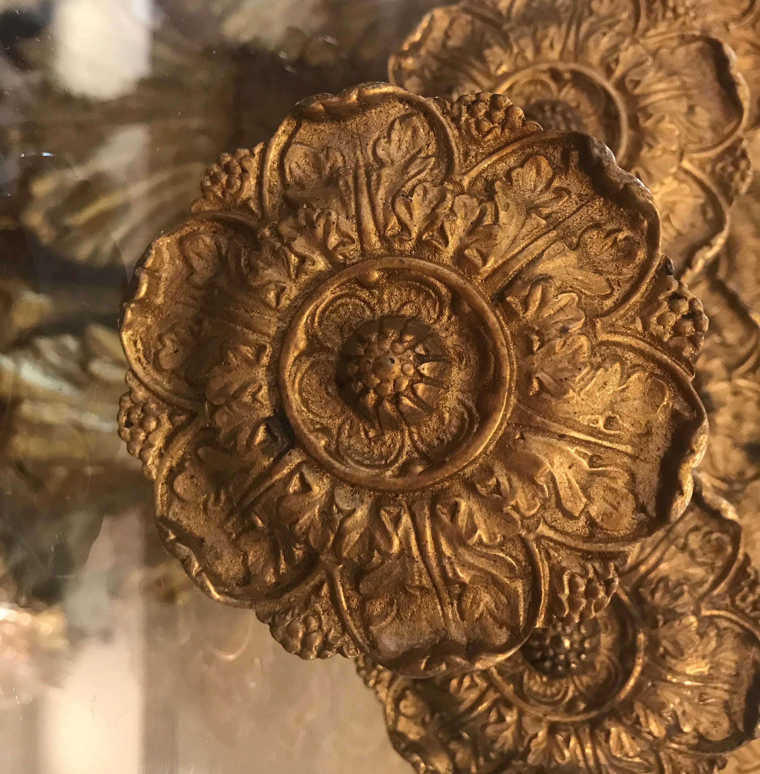 A set of 10 cast gilt bronze drapery tie back holders, the beautifully cast rosette fronts with rob back with a screw point. 19th century and a rare find of a set of 10. Measures: 3.5 inches in diameter.