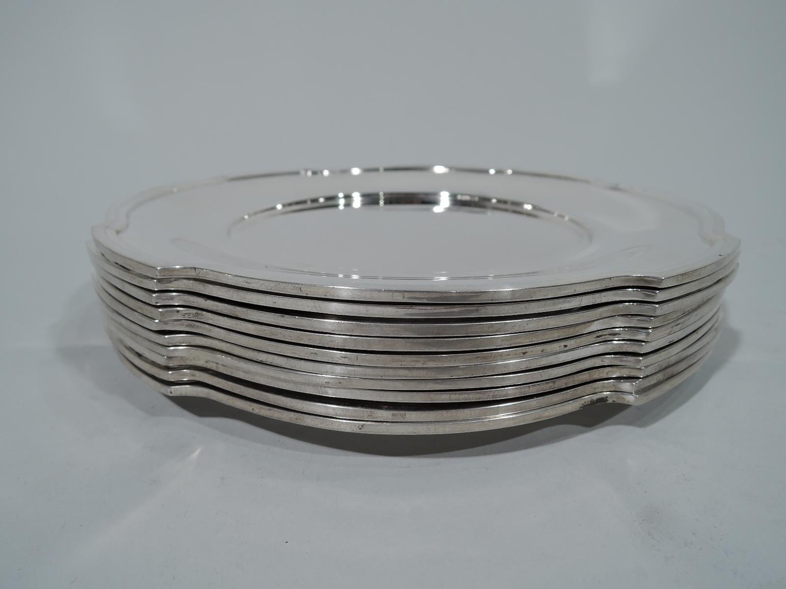 Ten Art Deco sterling silver appetizer plates. Made by R. Wallace & Sons in Wallingford, Conn. Each: Circular with well and shaped and molded rim. A smart set in unusual form. Hallmark includes no. 1850. French import mark. Total weight: 76.5 troy