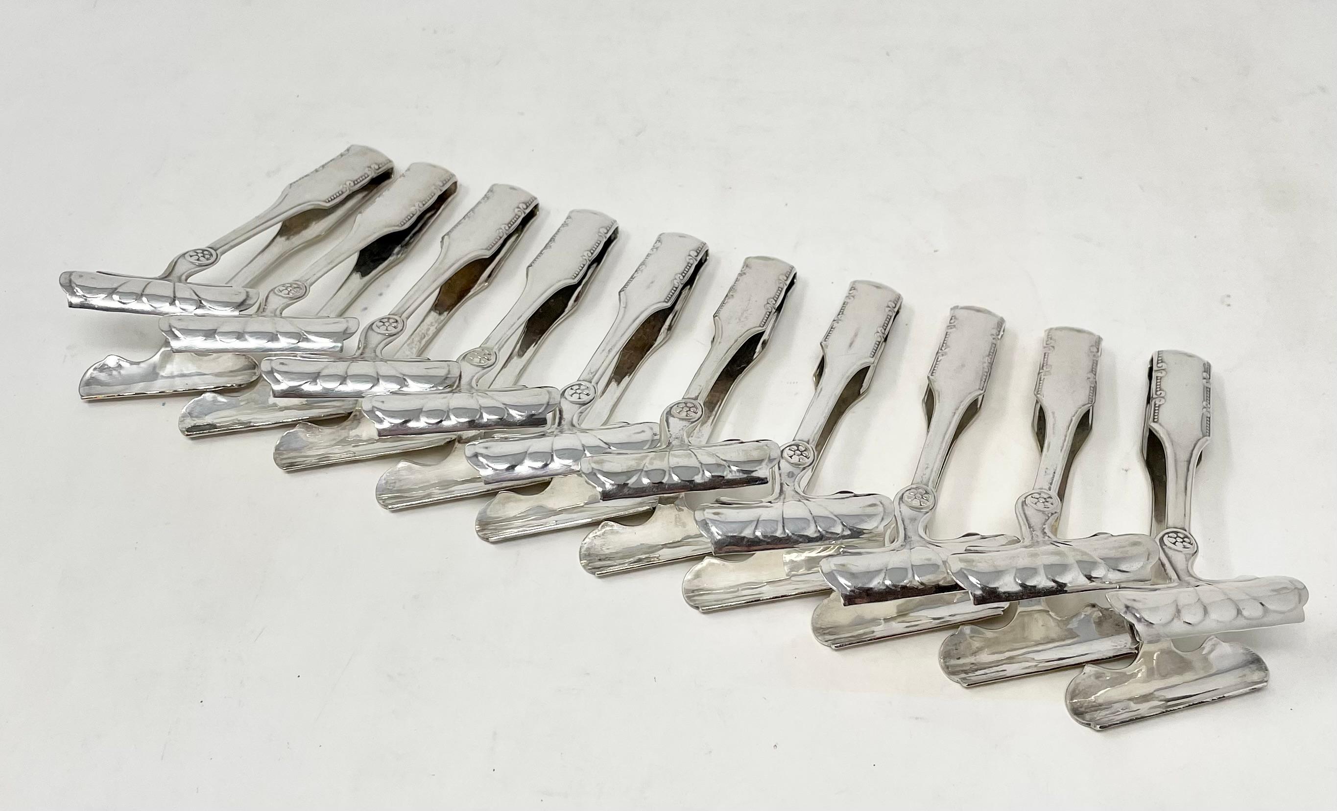 Antique set of 10 Art Nouveau design silver-plated asparagus tongs, circa 1910.
Will work beautifully as server tongs for ice cubes, lemon wedges, pickles & olives, cheeses & meats and a variety of hors d'oeuvres.