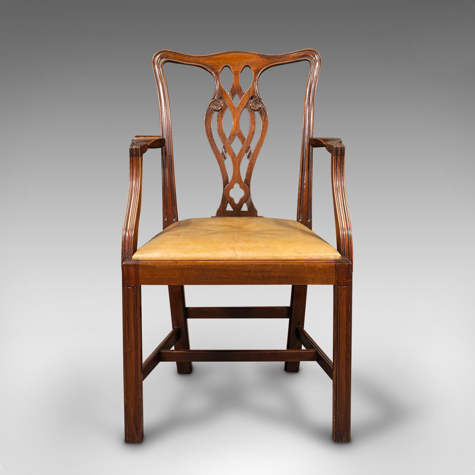 This is a long set of 10, leather seated antique carver dining chairs. An English, mahogany elbow seat with Chippendale revival taste, dating to the late Victorian period, circa 1900.

Superb suite of ten carver chairs for the grandest of dining
