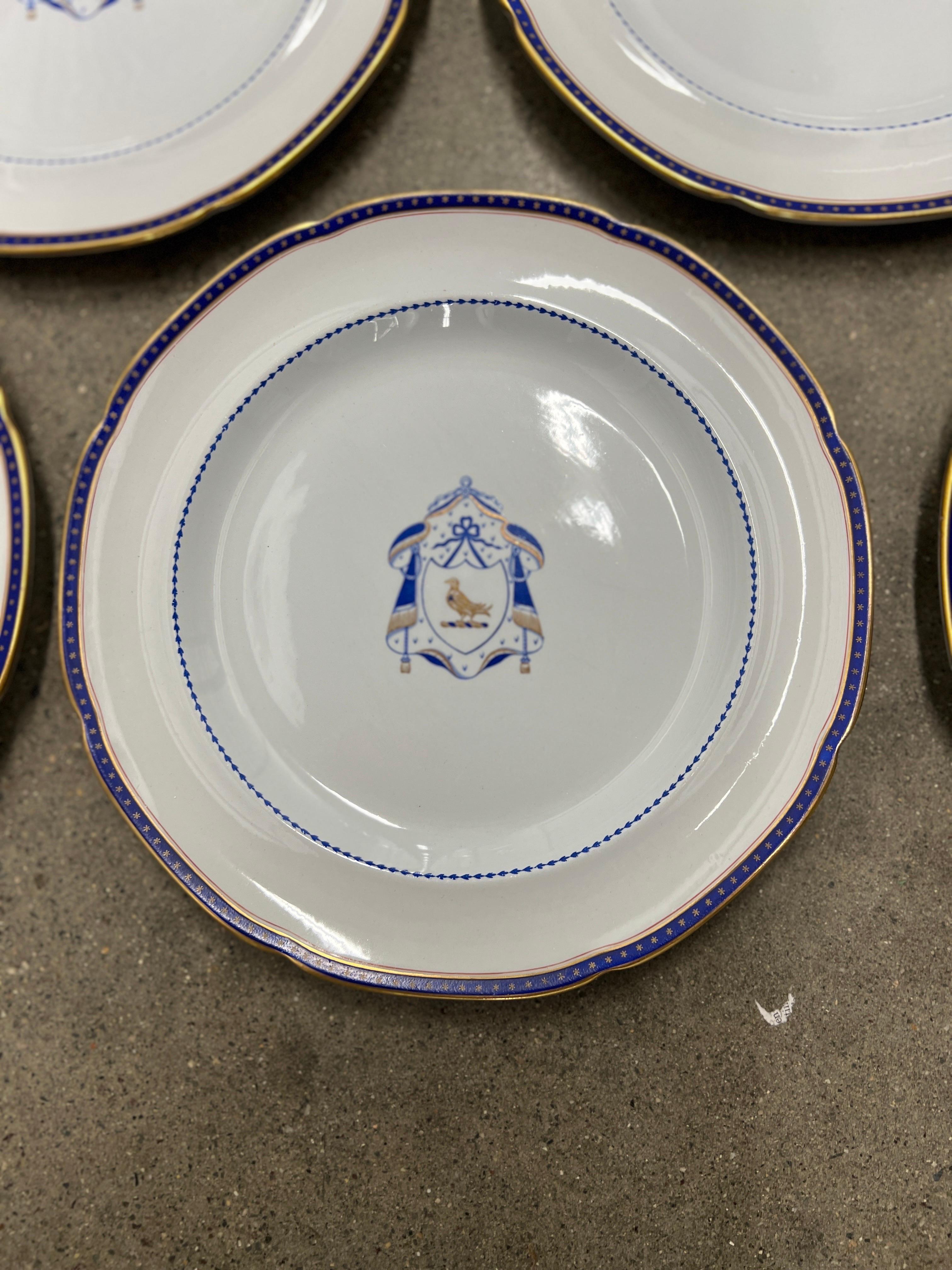 A semi-antique set of 10 Copeland Spode New Stone (made 1920-1960) dinner plates having a navy a armorial central medallion adorned with a bird of prey and a navy and gold leaf around the periphery. Marked to verso accordingly. 