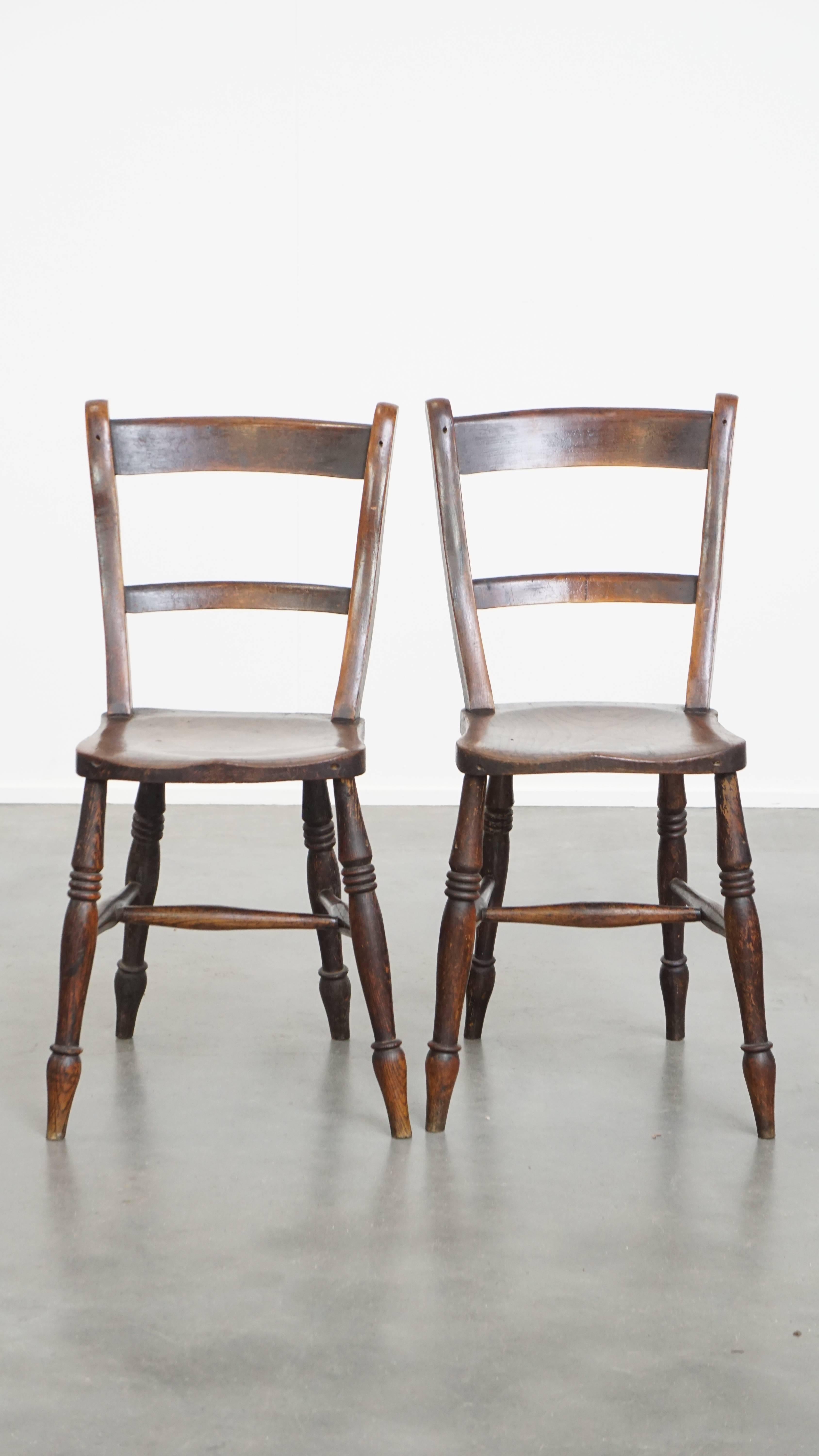 Offered is this timeless and elegant set of 10 antique English Oxford dining / kitchen chairs with a warm color scheme.
This wonderful set of 10 antique Oxford chairs is not only perfectly suited for a homely environment, but also works beautifully