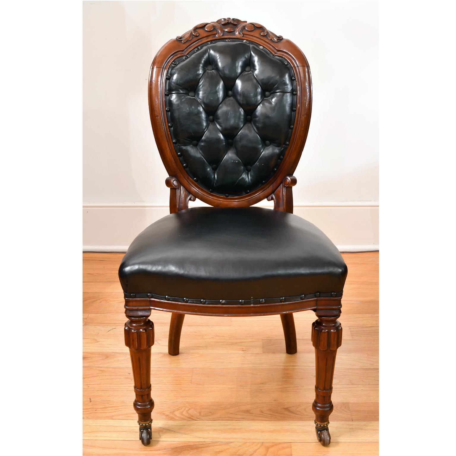 A very handsome & finely crafted set of 10 early Victorian dining chairs in mahogany with black leather upholstery on balloon back & seat. Chair frames are embellished with acanthus foliate carvings on crest rail, with turned & reeded front legs