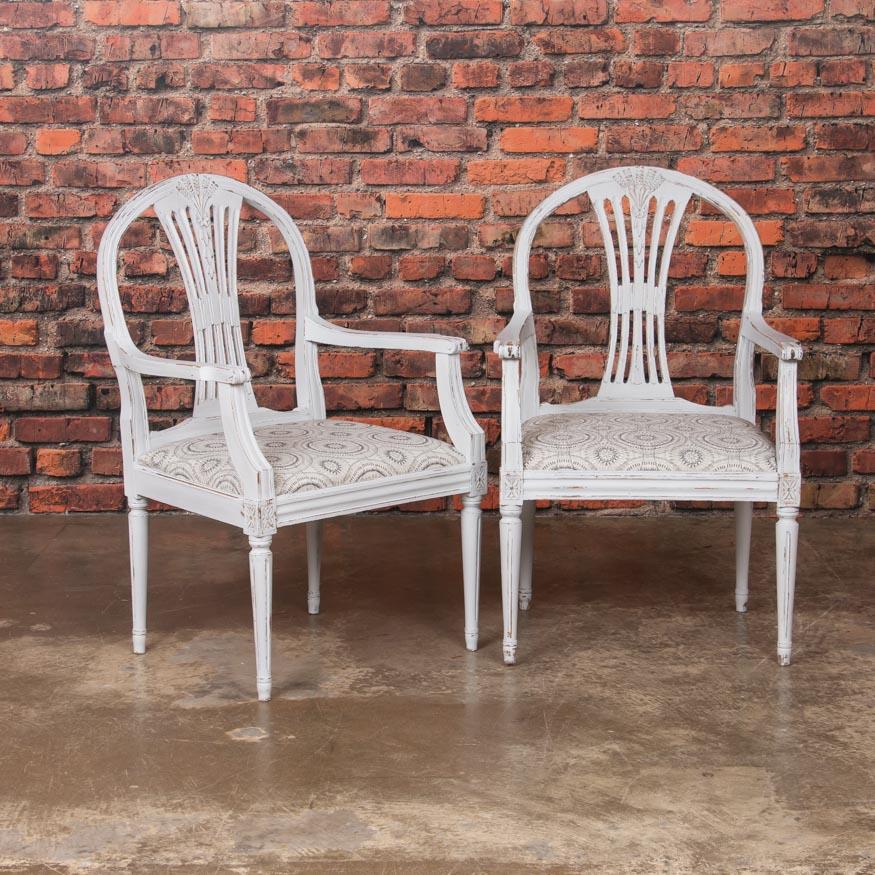This set of 10 antique Gustavian Swedish chairs have a lovely light grey, slightly distressed paint which creates an alluring contrast with the hardwood beneath. This timeless color of pale grey, (almost white) paint beautifully accentuates the