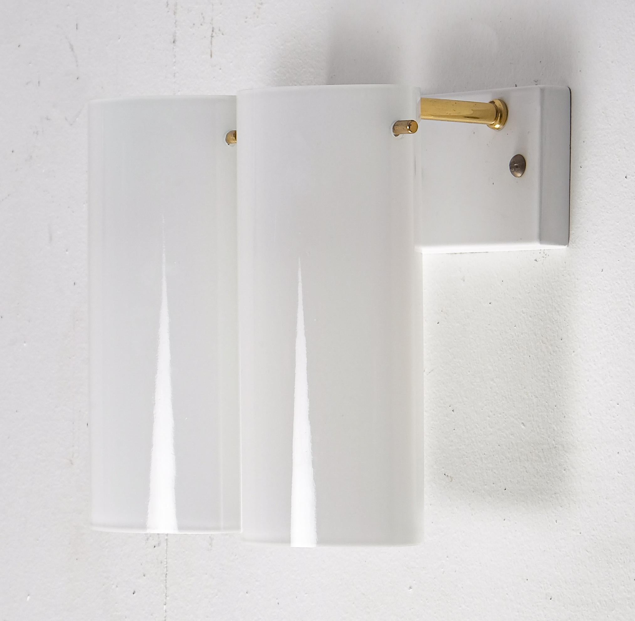 Rare model. Set of 10 available, listed price is for a single wall lamp.
2-armed, opaline glass and brass. Produced by Fagerhults, late 1960s.