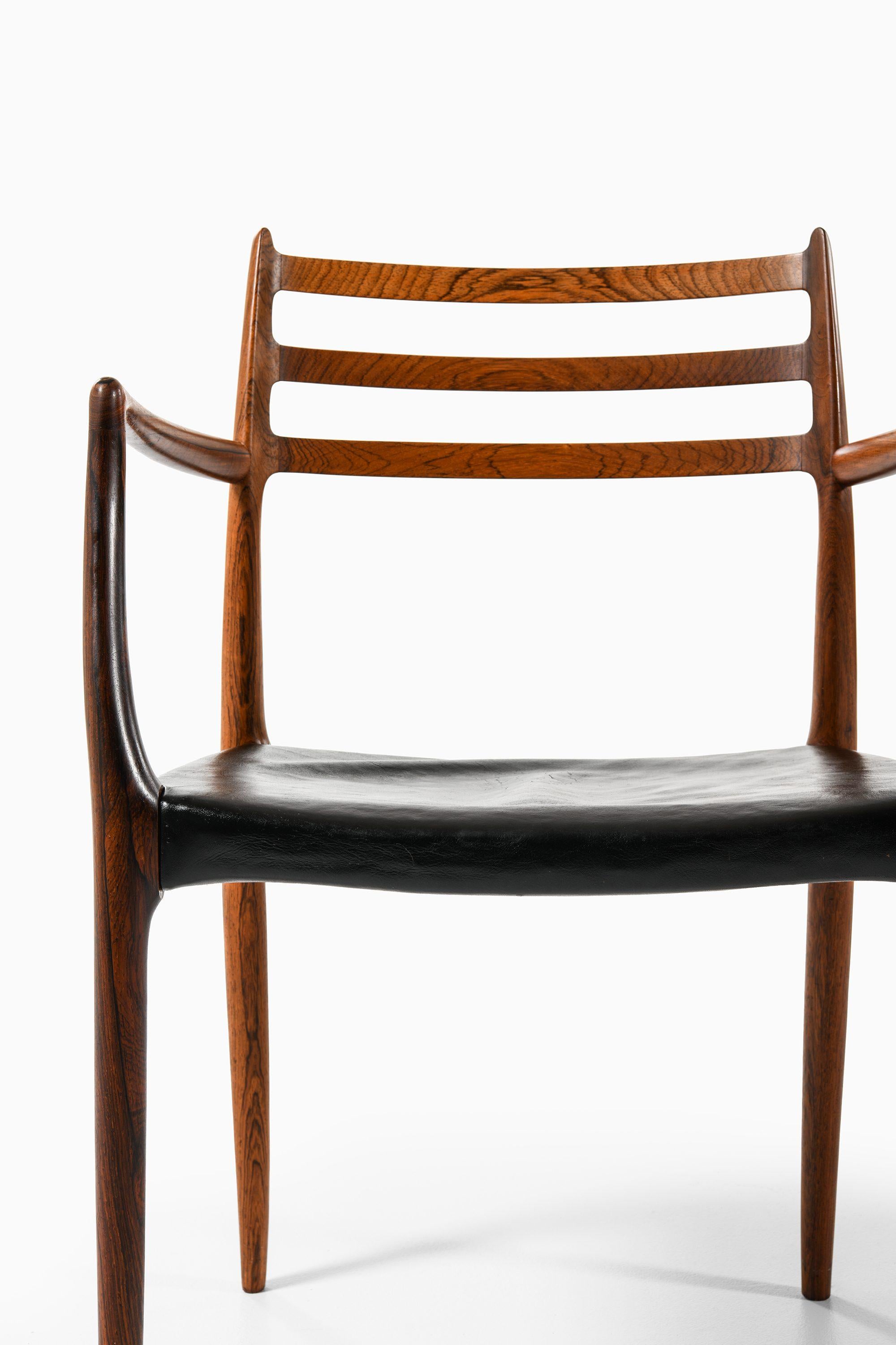 Scandinavian Modern Set of 10 Armchairs in Rosewood and Black Leather by Niels Otto Møller, 1960's For Sale