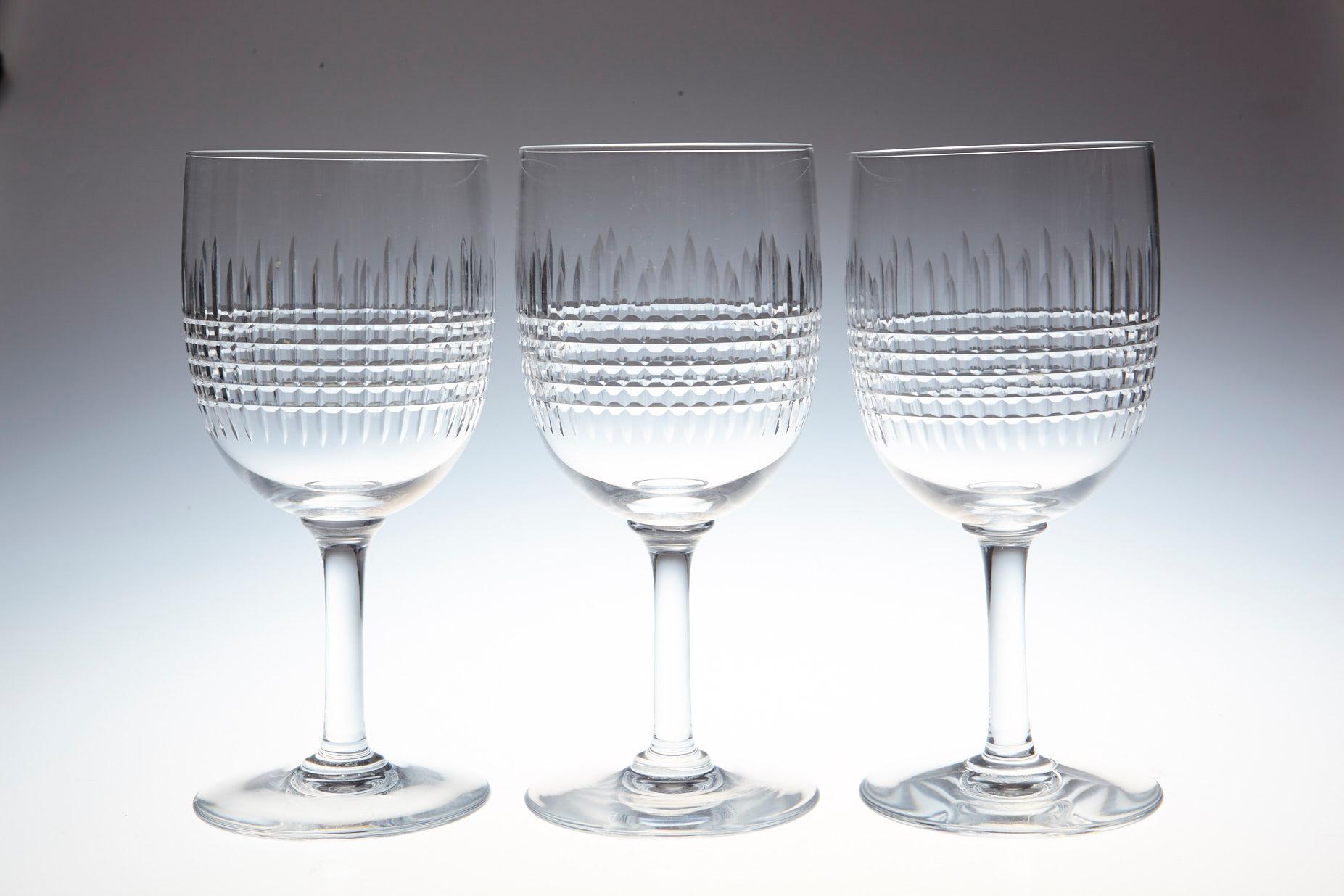 Rare set of 10 Baccarat crystal white wine glasses in the 'Nancy' pattern. 
This classical shape with finely banded vertical and horizontal cuttings is one of Baccarat Crystal,'s most popular patterns, first created in 1909 but is discontinued