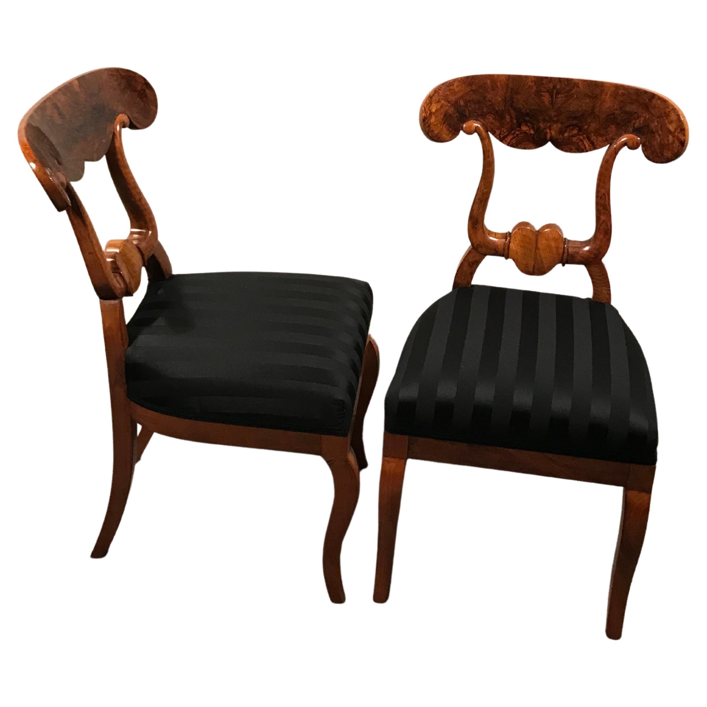This exquisite set of 6 original Biedermeier chairs is a rare find. 
The so called original Biedermeier Ochsenkopf-Stuehle (ox-head chairs) get their name from their beautifully designed back. They date back to around 1820 and come from Southern