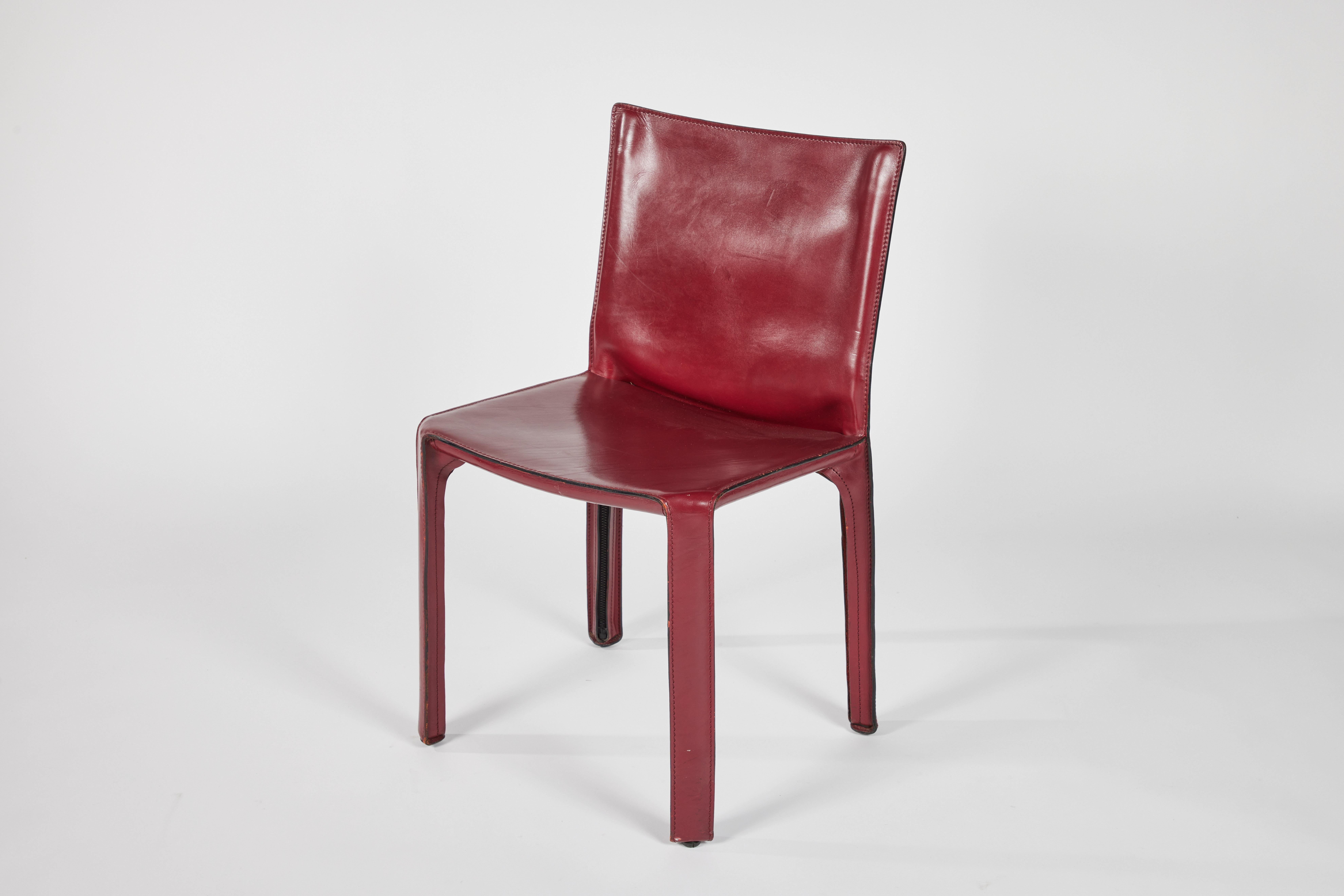 A set of 10 burgundy cab dining chairs, designed by Mario Bellini and manufactured by Cassina. 1977. 

Cab is the world’s first free-standing cowhide design chair, informed by the relationship between the skeleton and the skin; an authentic