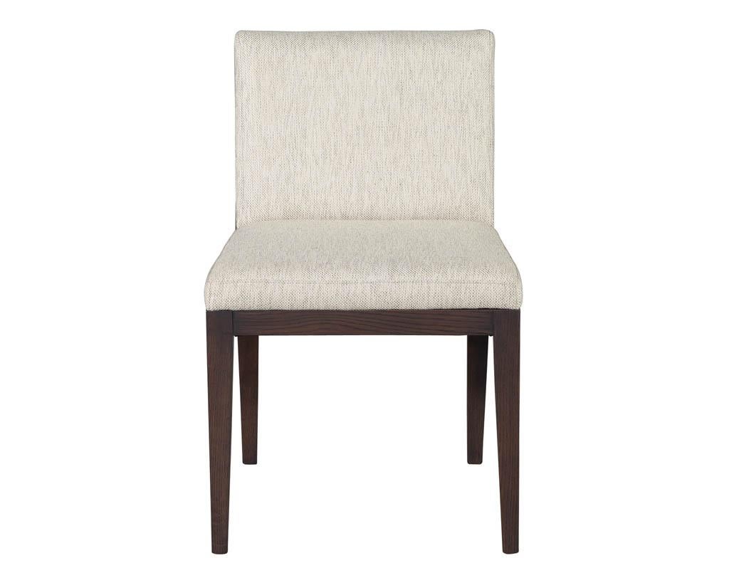 Set of 10 Carrocel Custom Verona Dining Chairs. Featuring sleek curved back leg design composed of oak material. Finished in a satin natural espresso color showcasing the unique knots and grain details in the wood. Completed with textured light grey