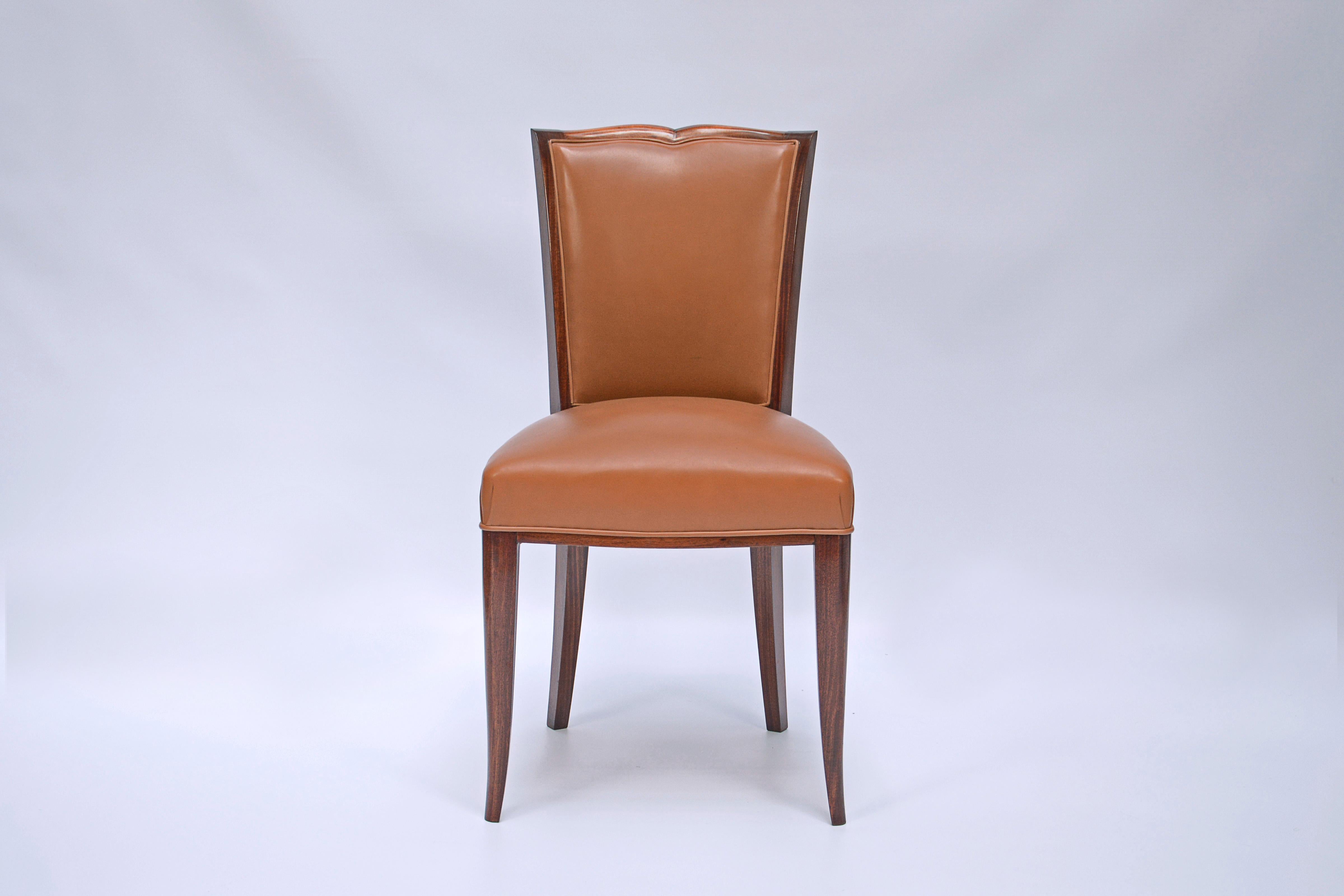 Set of 10 chairs and 2 armchairs designed by Maurice Jallot (1900-1971). Birch wood and leather upholstery. Table and buffet from the same set are also available.

France, CIRCA 1940.