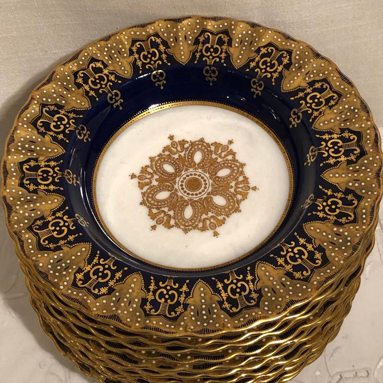 Set of ten Copeland Spode cobalt wide rim soup bowls with raised white enamel jeweling and raised gilding. These wide rim soups make an elegant table setting to present to your special guests. With these wide rim soups, you can set your table fit