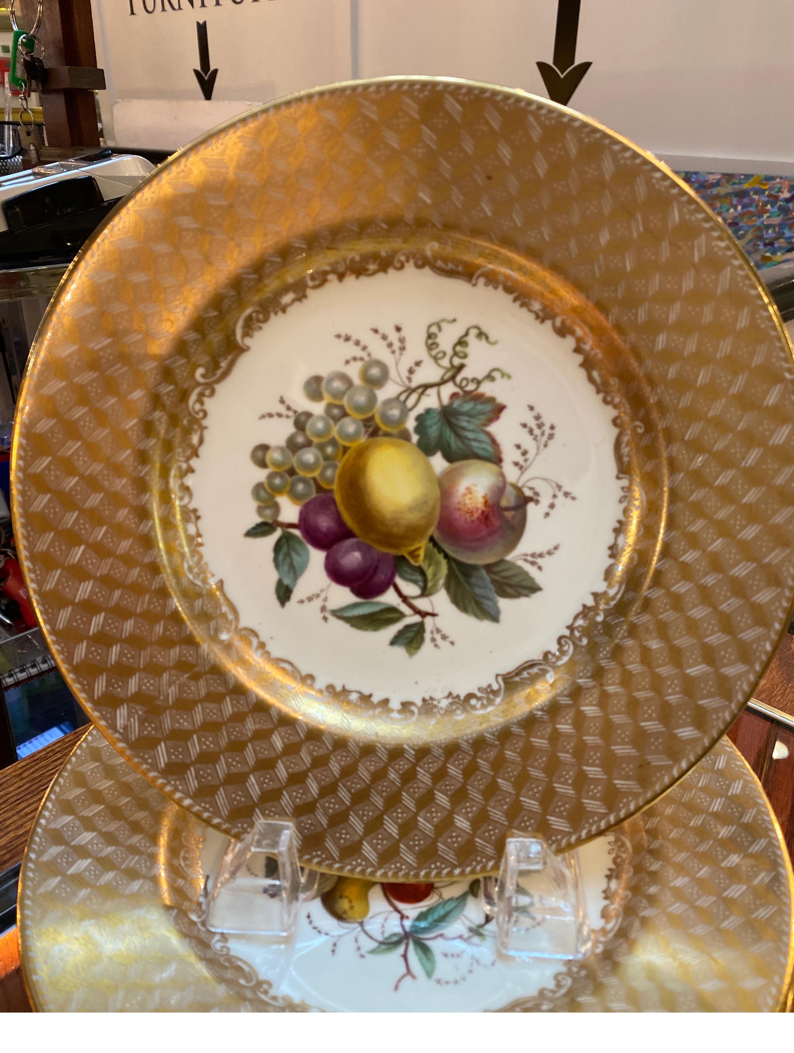 Un ensemble opulent de 10 assiettes de 9 pouces de diamètre peintes à la main, Angleterre Circa 1900-1910. Ces assiettes, dont le centre est peint à la main de motifs de fruits et dont les bordures sont incrustées d'or, portent la marque de Copland