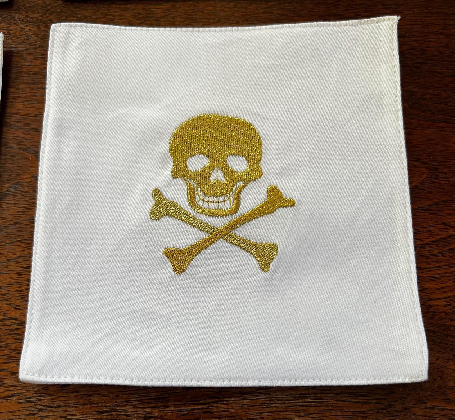 Modern Set of 10 Cotton Cocktail Napkins with Gold Skull and Crossbone Embroidery For Sale