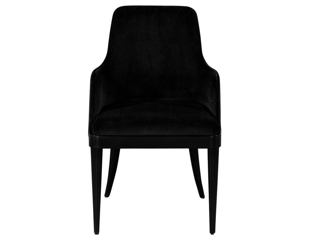 Set of 10 custom black modern dining chairs by Carrocel. This transitional style dining chair features a curved backrest and a seat inset from the wooden base. Sitting atop tapered curved rear legs. Finished in a high gloss black lacquer finish with