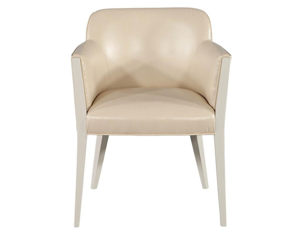 Set of 10 Custom Modern cream dining chairs in Ostrich print faux leather. Crafted in Canada with solid wood frame. Featured in shadow white lacquer with contrasting cream ostrich printed faux leather. Unique curved back modern design with elegant